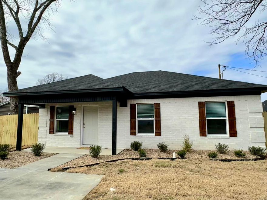 Welcome home to this beautifully crafted new construction offering the perfect blend of modern style and functional living. With 4 bedrooms and 2 full baths thoughtfully designed within 1,138 square feet, this home maximizes space without sacrificing comfort.  This open-concept layout features wood-look flooring, recessed lighting, and a stylish kitchen with granite countertops, white cabinetry, and brand new stainless steel appliances. Both bathrooms include granite counters and contemporary finishes. Exterior highlights include white brick, black trim, wood shutters, a covered front porch, and a fully fenced backyard with patio. Move-in ready and built with low-maintenance and perfect for homeowners or investors alike!