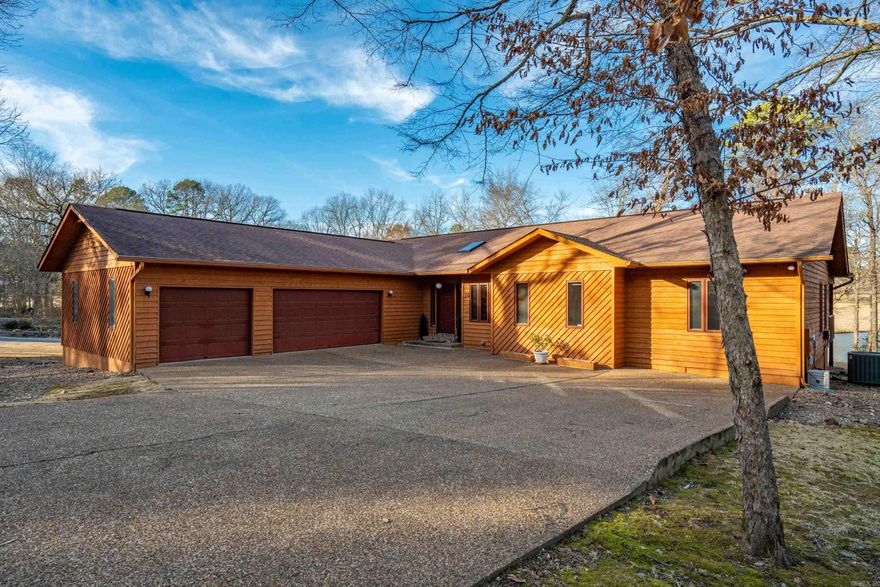 Exactly 1,200 characters — MLS & Zillow optimized:  GOLF FRONT LIVING WITH DYNAMIC LAKE VIEWS! This one-owner home is ideally positioned on a relatively level, easy-maintenance lot offering sweeping golf course frontage paired with beautiful lake views. Rustic wood finishes and vaulted ceilings create warmth and character throughout the spacious one-level layout. A three-car garage provides ample room for vehicles, storage, and hobbies. The Arkansas room showcases a stunning wall of windows, filling the home with natural light and capturing the ever-changing outdoor scenery. The split floor plan offers privacy, with a generous primary suite separate from guest spaces. Office or third bedroom includes an area designed for a future closet, allowing flexible use. Enjoy both a formal dining area and a breakfast area, along with a spacious living room ideal for entertaining or relaxing after a day on the course. Located in Hot Springs Village, this super convenient location provides quick access to golf, lakes, fitness centers, trails, and all Village amenities, delivering comfort, views, and lifestyle in one exceptional property. Perfect for full-time living or vaca retreat! NEW ROOF!