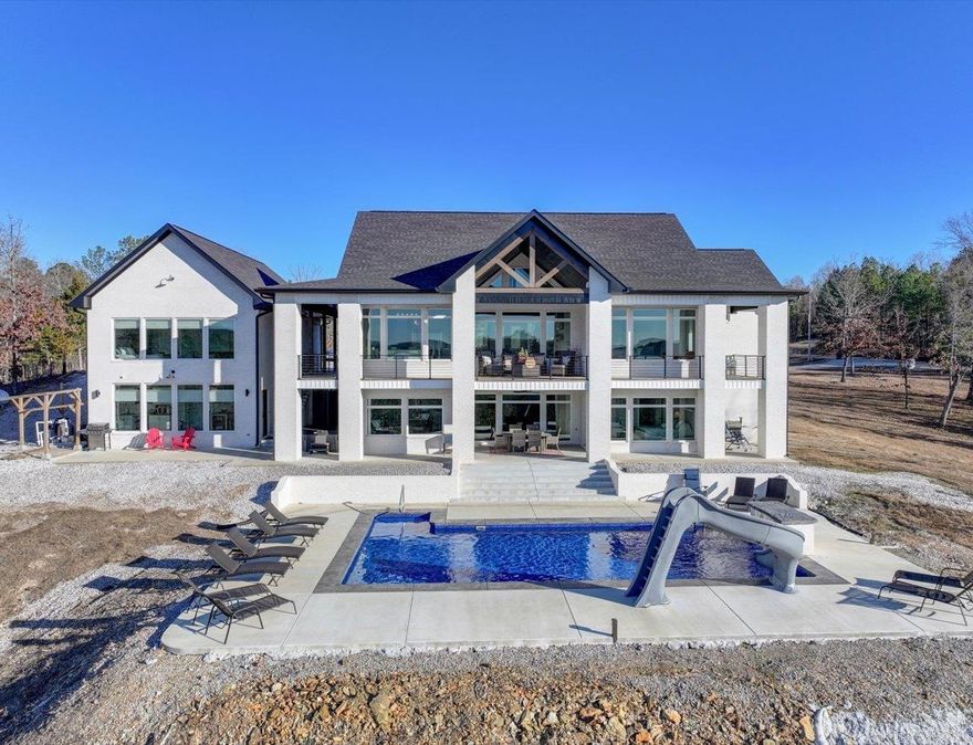 Luxury. Views. Privacy. Opportunity. This is more than a home-it’s a destination. Perched on 6 private acres with sweeping views of pristine undeveloped Arkansas landscape, this stunning like new estate offers a rare blend of luxury, privacy, and investment potential. The main residence features 5 beds, 3.5 baths and 4430sf of thoughtfully designed living space, ideal for both grand entertaining and comfortable everyday living. A separate guest cottage offers 1 bed 1 bath and approximately 700sf, perfect for visitors, multigenerational living, or short term rental income.  Designed with versatility in mind, the bottom level of the main home offers a fully functioning kitchen, laundry area, and additional bedrooms/bathroom, all opening directly to the pool. Expansive outdoor living areas showcase a resort style 18x36 pool and hot tub, perfectly positioned to capture breathtaking sunsets stretching from corner to corner. With approximately 5130sf between the main home and guest cottage, the layout provides flexibility, privacy, and exceptional hosting potential. Located just minutes to Lake Ouachita, Blue Springs-home of the famous AR Crystals, and Hot Springs Village.