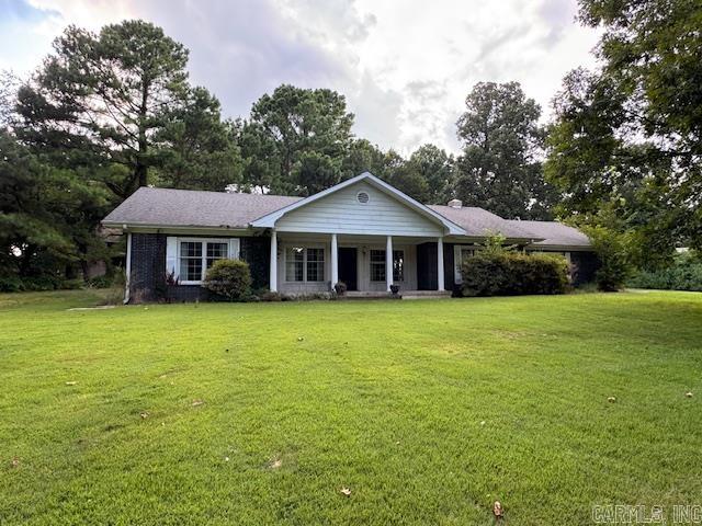 CLASSIC BRICK COLONIAL on 1.2 acres with mature trees and timeless charm. This 1,678 sq ft home offers a smart split floor plan with 2 spacious bedrooms and 2 full baths. The living room steals the show with a full brick wall and centered gas fireplaceāperfect for cozy evenings. A galley kitchen with spacious pantry connects to a formal dining room, ideal for hosting. (Refrigerator, dish washer, electric range & microwave stay.) The master suite includes a walk-in closet and private bath, while the guest bedroom is just steps from a second full bath. As you enter the home from the garage youāll pass through a large utility room with lots of storage (washer and dryer stay). Outside, enjoy the peace and shade of towering trees in the front yard, a back patio for relaxing or grilling, and a two-car garage for convenience. Solid, well built, and ready for the next chapter.