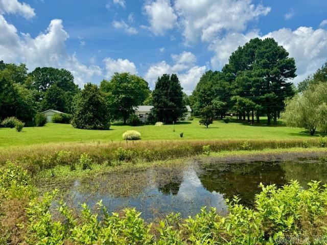 Discover country living just minutes from town with this beautiful 4-bedroom, 2.5-bath home nestled on 3.1 well-manicured acres at the end of a paved dead-end streetāonly 5 minutes from the Pocahontas city limits. Enjoy privacy, serenity, and the simple pleasures of life in a scenic setting that includes a picturesque pond and plenty of space to roam. This thoughtfully designed home features an open-concept floor plan ideal for modern living, with spacious rooms that flow seamlessly for entertaining and everyday comfort. The primary suite offers a private retreat with an attached bath, while three additional bedrooms provide space for family or guests. A large addition currently serves as a family room with a gas log fireplace, vaulted ceilings and a sunroom overlooking the backyard, but offers flexible potential to be converted into a 5th bedroom or in-law suite. Downstairs, you'll find a finished partial walk-out basement beneath the addition, great for storage or a storm shelter. With a private, park-like setting and easy access to town, this unique property offers the best of both worldsācountry charm and city convenience. Roof replaced 2022.