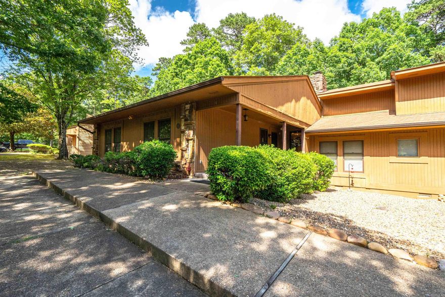 Charming One-Level Townhome near the West Gate of Hot Springs Village.  This furnished one-level townhome offers an inviting blend of comfort and convenience. 3 spacious bedrooms and 2 full bathrooms, perfect for investors, families or those who love to entertain. As you step inside, you'll be greeted by an open living area featuring a cozy fireplace, ideal for relaxing evenings. The homeowner loves the easy entry shower and grab bars for main bedroom shower.   One of the standout features of this home is the screened porch, providing a peaceful retreat where you can drink your morning coffee or unwind after a long day, all while taking in the beautiful surroundings. Newer vinyl windows and no carpet! The lower level offers a versatile bonus room that can serve as a game room, workshop or additional living space to suit your needs.  This townhome is being sold furnished, ensuring a move-in-ready experience.