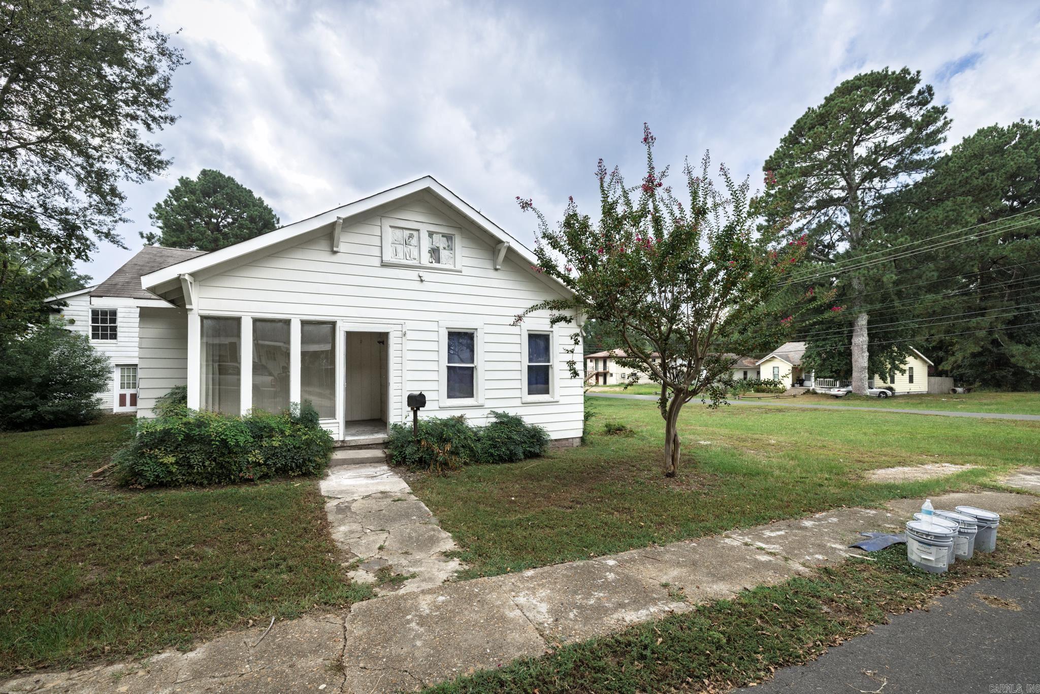 This property offers incredible versatility with a two-bedroom, one-and-a-half-bath main house and a separate one-bedroom, one-bath guest apartment, all situated on an oversized lot just minutes from Henderson State University. The main house has been thoughtfully updated with brand-new LVP flooring throughout, an updated bathroom featuring a beautiful walk-in tile shower, a spacious primary suite closet, and a newer HVAC unit and roof for peace of mind. The guest apartment provides excellent income potential, perfect for student housing, a long-term rental, or a private space for guests. This unique property combines comfort, convenience, and investment opportunity in one exceptional package.