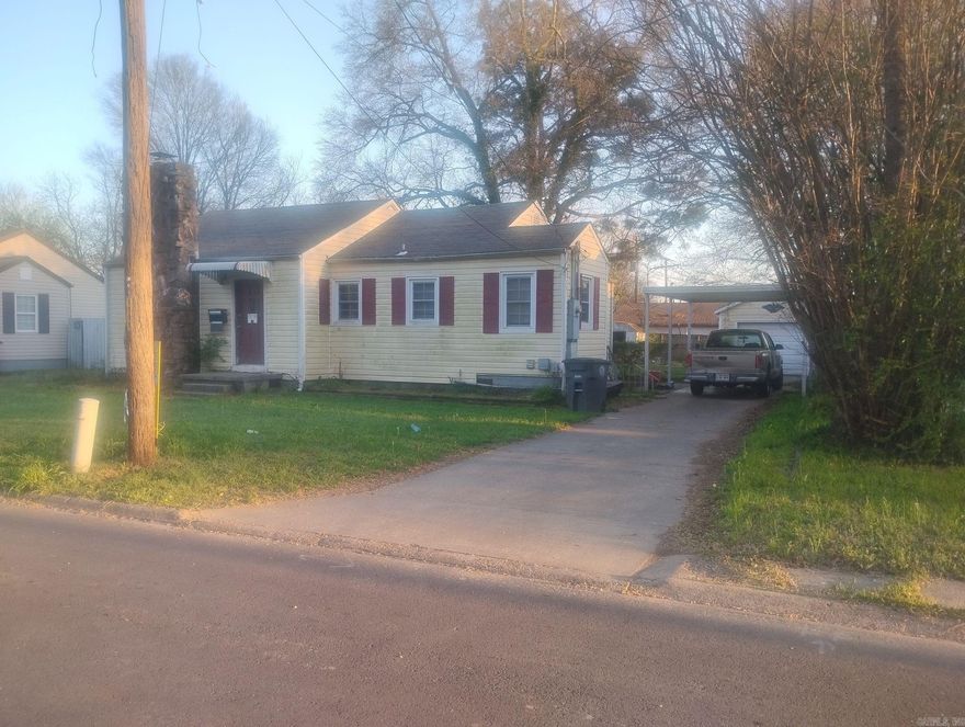 Cute fixer upper in in a nice convenient Searcy location.  1 Bathroom has been gutted, as well as one bedroom, once complete you will have a 3/2. Carport, single car garage. Lovely stone fireplace in the living room. Updated windows and vinyl siding. Finish the updates and it would make a nice home or great rental (given the location). Nice sized back yard with chain link fencing.