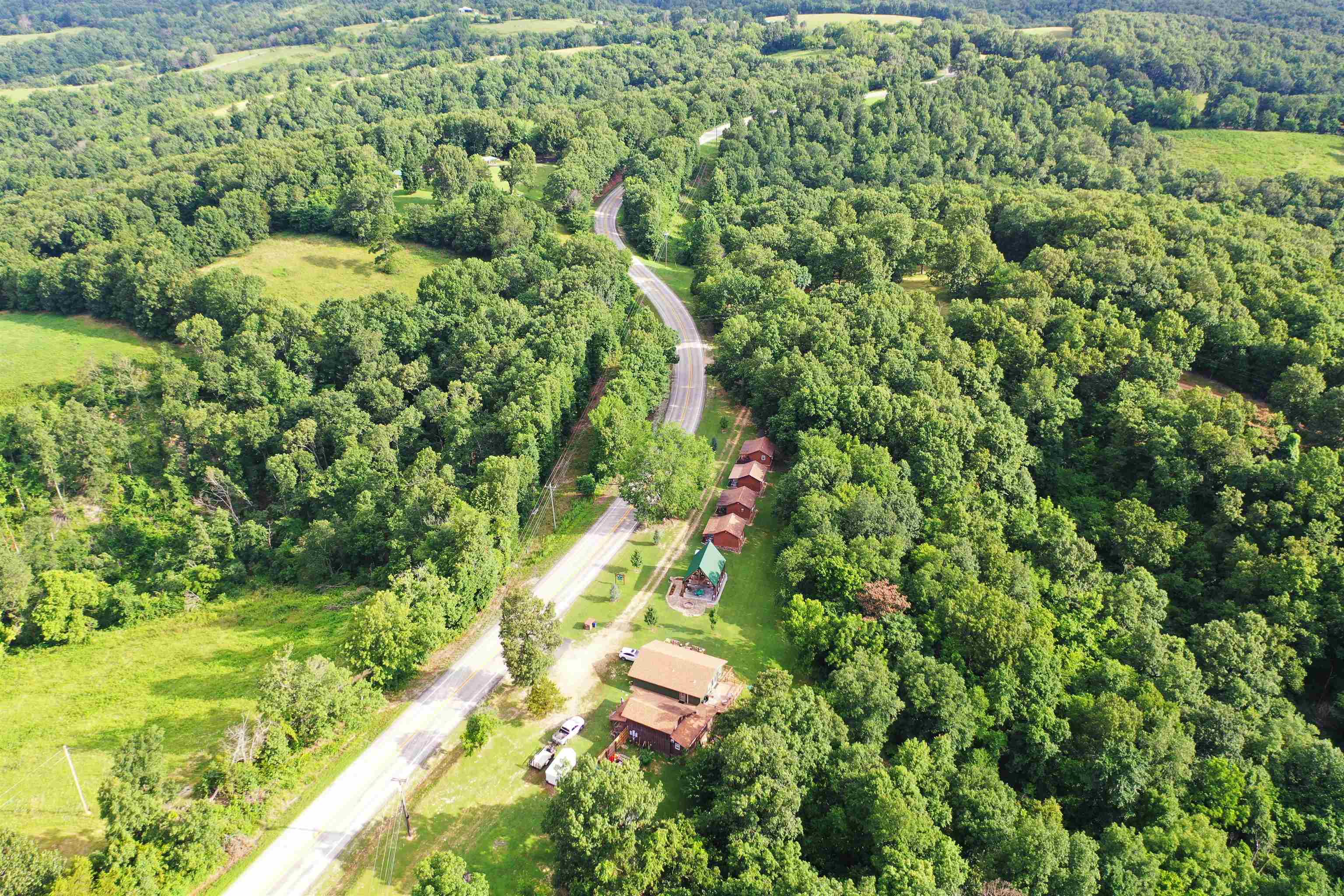 TRULY A DIAMOND GEM OF A RESORT LOCATED IN THE OZARK MOUNTAINS. ONLY A FEW MINUTES FROM THE FAMOUS BUFFALONATIONAL RIVER. WHERE YOU CAN ENJOY FISHING, FLOATING, AND HIKING FOR MILES AROUND. THIS POPULAR RESORTHIDEAWAY HAS BEEN COMPLETELY UPDATED INSIDE & OUT WITH AMAZINGLY DETAILED WORKMANSHIP, INCLUDING THECABINS, MAIN HOUSE, & LARGE PAVILION FOR THE GUESTS TO ENJOY WHILE GUESTS STAY. THEY CAN HIKE AND EXPLORE THE17 WOODED ACRES LOCATED BEHIND THE CABINS, OR JUST TAKE IT EASY ON THE COVERED & OPEN DECKS, OR THE PAVILION,AFTER A FUN FILLED DAY AT THE BUFFALO RIVER. THIS PROPERTY IS A TURN-KEY RESORT WAITING FOR A NEW OWNER.EXPLORE ALL THE UPSIDE POSSIBILITIES THE RESORT HAS TO OFFER.