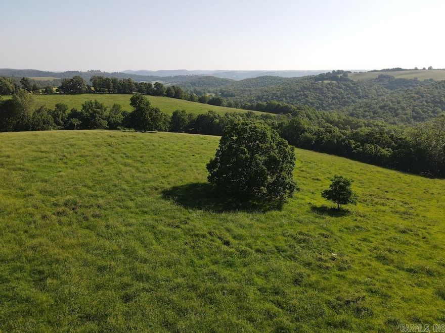 You rarely see a property like this become available, and this place doesn't disappoint. Finding the "ideal" farm is the dream of most landowners. Occasionally, it happens, and this is one of those occasions. Located just over 6 miles from Harrison, you are a few minutes from all the amenities one could ask for. This property has excellent access right off Mill Hollow Rd., a wonderful build site with breathtaking views of the surrounding Ozark Mountains. Getting trailers, livestock, or equipment in and out is no problem at all. The rolling hills, mountains, hardwood timber, and topography are picturesque representations of all this incredible region has to offer. The property is mostly fenced with some cross fencing, and when it's not hunting season, the land is leased for cattle to aid in upkeep and pasture management. Cascading off the hills are the hardwood bottoms, massive flats, and benches that are littered with a stunning stand of timber. Mostly White Oak, Red Oak, and Walnut litter the property with several stands of phenomenal saw logs. There are multiple patches of dense cover, native browse thickets, and cedar glades that prove to be part of the magic.