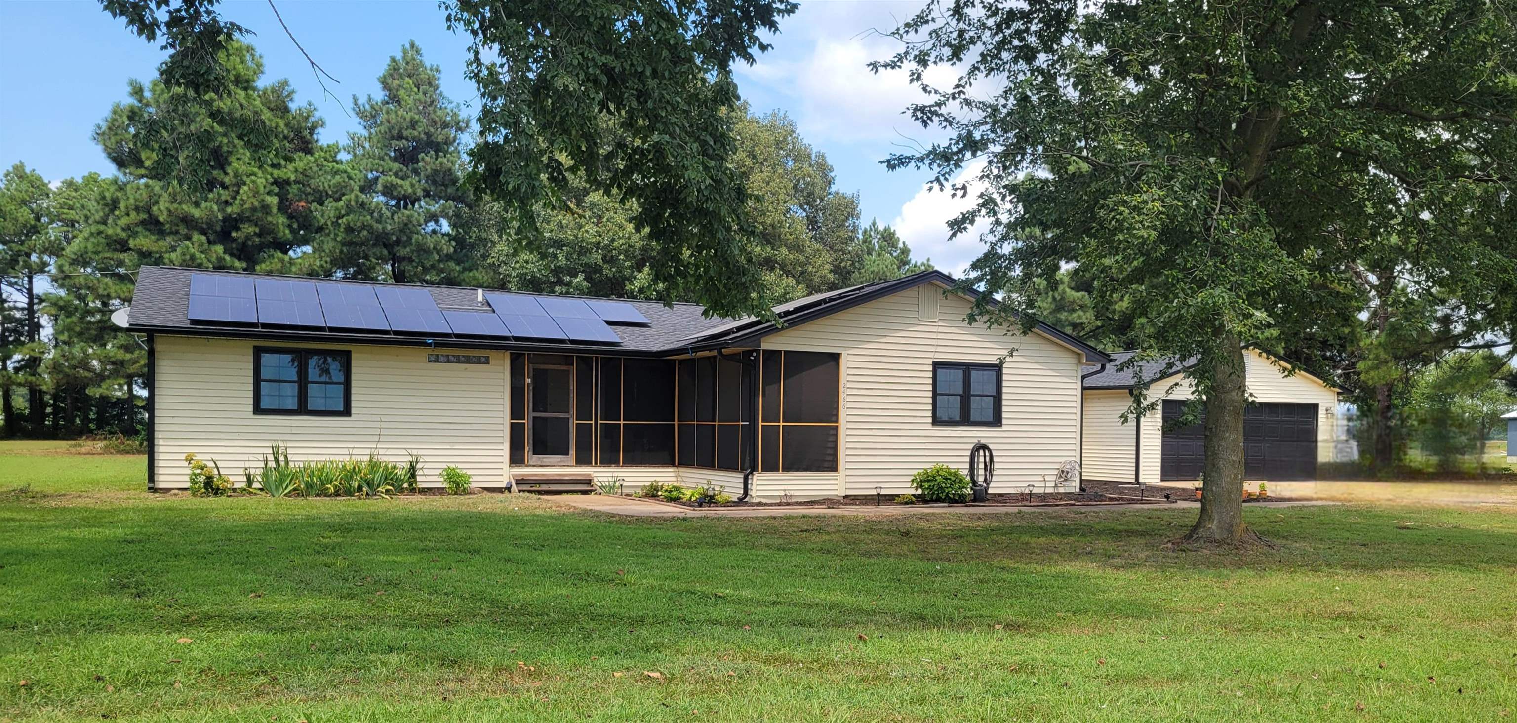 Updated home on two aces in Manila. Gorgeous updated kitchen with white cabinetry, gold accents, and new backsplash. Center island with storage. Split bedroom floorplan. Primary bedroom includes large walk-in shower. New roof. Attached 2-car garage and large yard with shade trees.