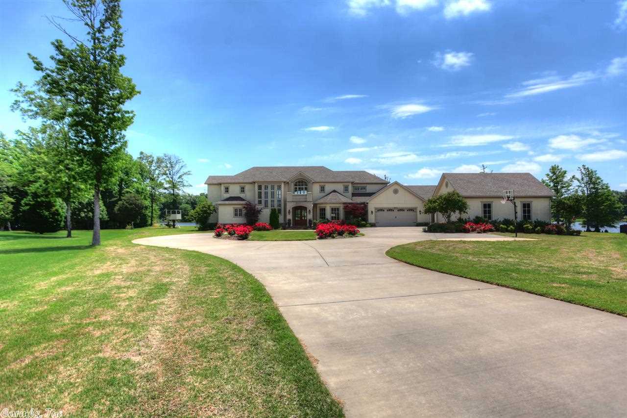 Custom built 5 BD home w/ a panoramic lake view from every room. Approx 4960 SF in main house & 1087 SF In-law quarters. Main level feature Mstr BD, office, formal living room, formal dining room, hearth room, half bath, & a gourmet kitchen. Upstairs has 4 BD's, 2 BA, study/computer landing, game room w/ fridge & sink. In-law quarters is also on the main level & can be accessed thru the garage it has 1 Bd, 1 Ba, den w/built-in bookcase, private deck w/ a beautiful lake view. House is occupied, call 4 appt
