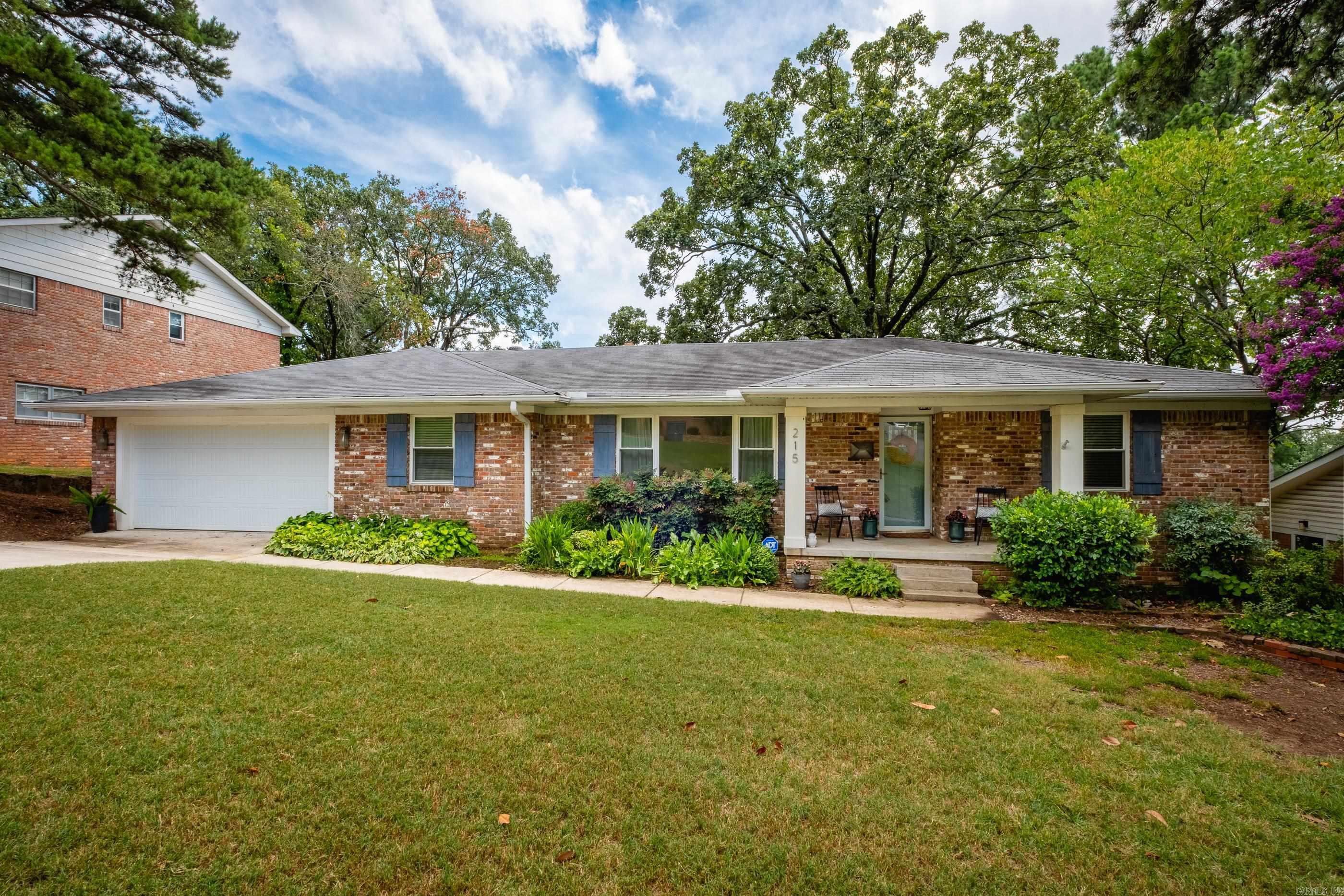 Come see this charming one level home in Midtown! This adorable 2 bed, 2 bath brick home has a cozy den with fireplace, a spacious separate living room, and a formal dining room perfect for entertaining. The primary suite features a newly tiled shower, double sinks, and a large walk in closet. There are original hardwoods and tile flooring throughout, no carpet anywhere. Enjoy the large laundry room and the convenience of a two car garage, a rare gem in this area. Step outside to a beautifully landscaped, park-like backyard with a deck that feels like your own private retreat. Don't miss this one!