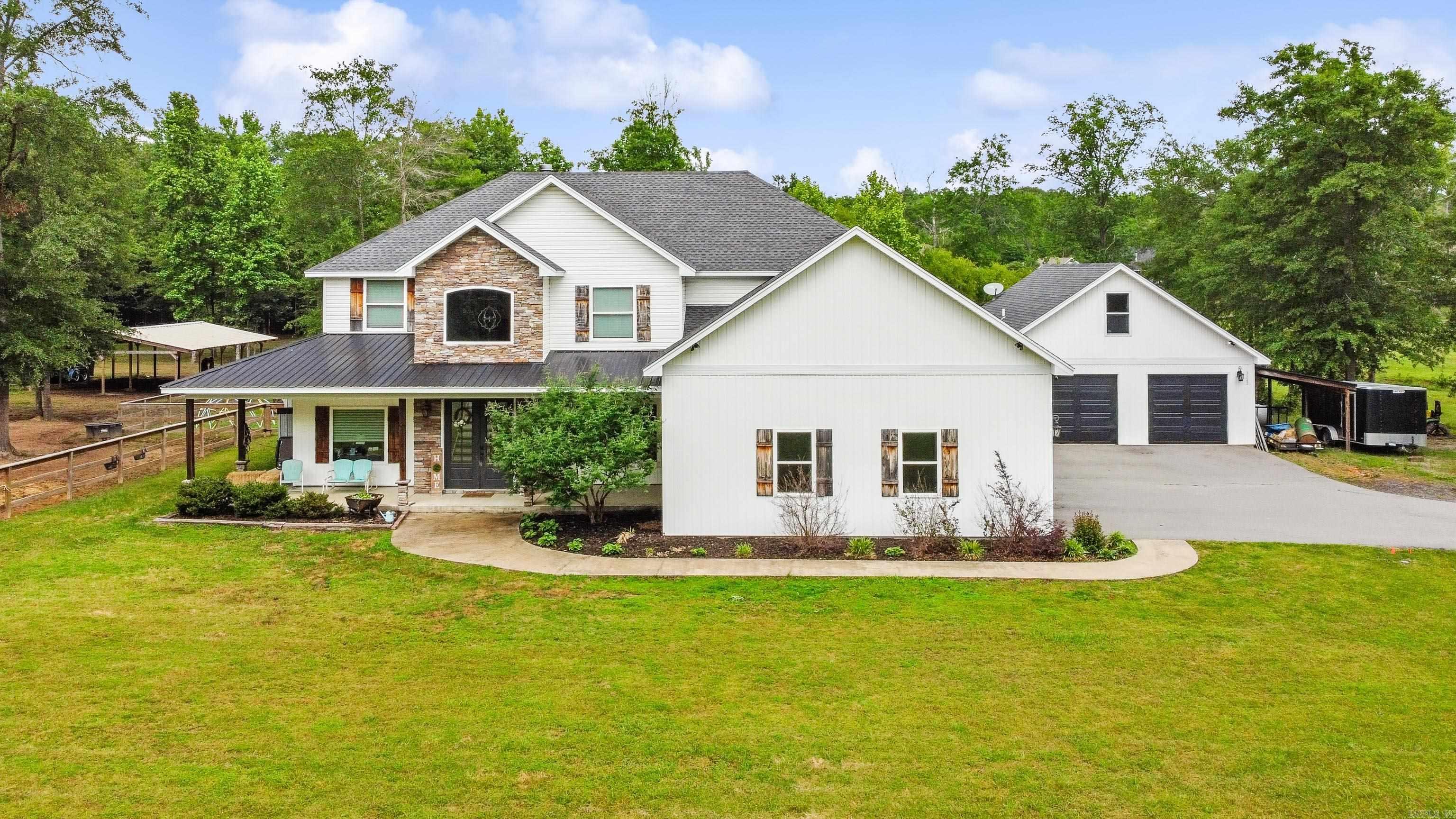 Escape the hustle and embrace refined country living in this breathtaking 3,900 sq. ft. custom home, perfectly situated on 7.21 acres just outside the city limits. 6 Bedrooms | 4.5 Baths | 2-Car Garage + Additional Garage with Guest Suite Gated Entrance & Grand Appeal: A private gated entry welcomes you to this striking home featuring natural stone exterior, nestled in a peaceful, scenic setting. Chef’s Kitchen: Designed for entertaining with a gas stove, double wall ovens, bar seating, walk-in pantry, and fridge that conveys. Primary Suite Sanctuary: Enjoy the luxury of his and her vanities, a walk-in tile shower, and a large soaking tub for ultimate relaxation. Outdoor Living at Its Finest: Step onto the screened-in back porch complete with a wood burning fireplace. Versatile Guest/Pool House: Located above the additional garage, this bonus living space is ideal for guests, a home office, or a private retreat. Spacious Laundry Room: Complete with washer and dryer that convey, and plenty of room. Inground saltwater pool with spacious patio, perfect for gatherings and relaxation. Call to schedule a private showing today and fall in love with your future home!