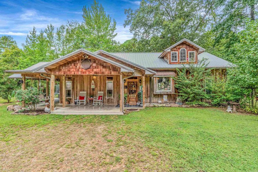 Full of character and timeless charm, this 3 bedroom, 2 bath home sits on 20.64 secluded acres, offering privacy and beauty in every direction. Inside, you’ll find that the living room showcases tongue and groove ceilings along with stunning real wood floors crafted from 100+ year old lumber. The kitchen features classic brick flooring, walnut countertops, a wet bar & a large garden window. The bedrooms offer vaulted ceilings which fill each room with light and space. The master suite includes a beautiful tiled, doorless shower and a spacious walk-in closet. Step outside to enjoy multiple covered patios, perfect for relaxing or entertaining. This property also features two storage buildings and a 20x31 metal shop for all your projects and hobbies. Adding to its uniqueness, the property is accessed by crossing the historic Shirley train bridge—a true piece of local history. With its own private well and complete seclusion, this property blends off grid vibes with modern comforts, making it a rare and special find.
