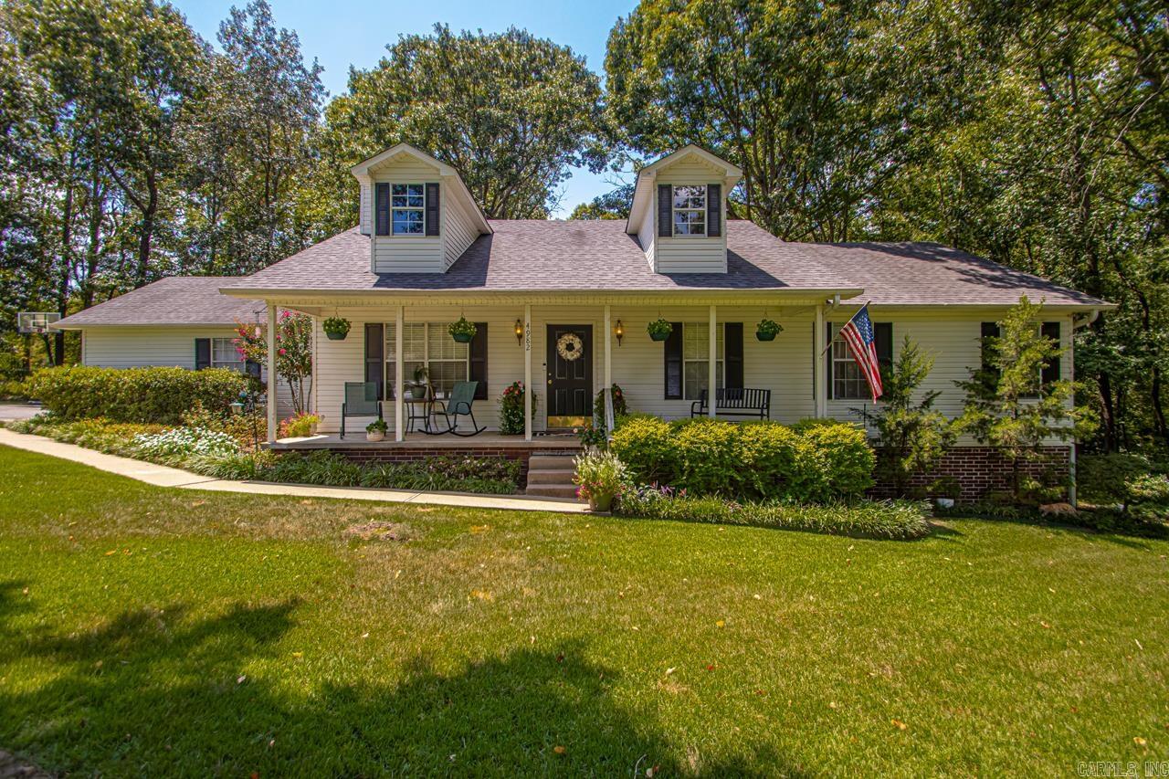This captivating farmhouse residence exudes a rural charm while offering convenient proximity to town. It features an enclosed garage that can be converted into an additional living space or a 4th bedroom with closet. The property comprises 4 bedrooms and 2 full bathrooms, with numerous updates throughout. The living room is equipped with a cozy fireplace, perfect for relaxation. The kitchen features a bar area, providing extra seating. All bedrooms are spacious, with ample closet space. The neighborhood is renowned for its festive holiday traditions, where families adorn their homes, creating a warm, family-friendly atmosphere. The area is ideal for walking and cycling, with a charming front porch perfect for enjoying morning coffee. This exceptional property is not to be missed. Storm Shelter. See Showing Remarks.