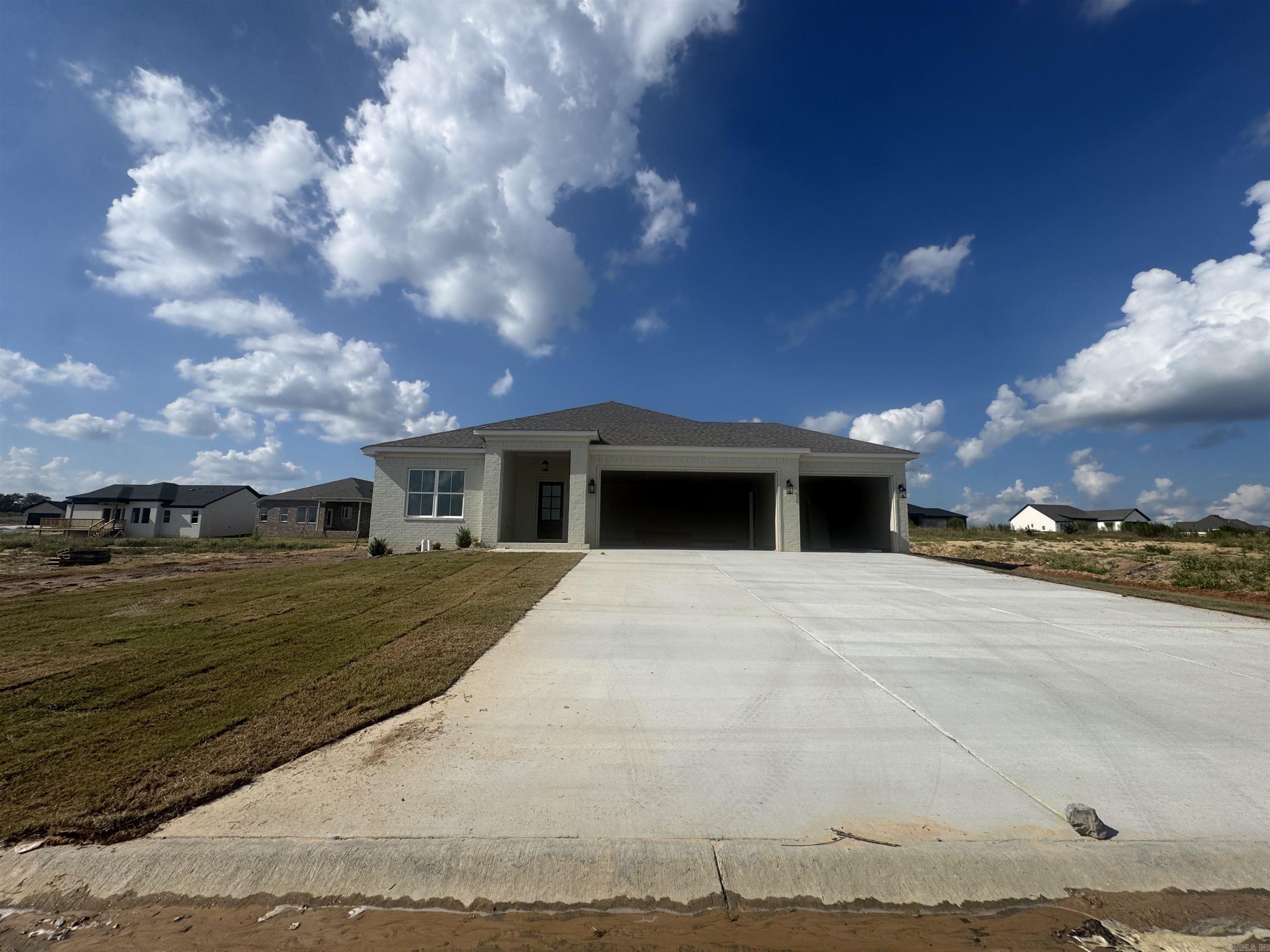 This open-concept home features large windows in the kitchen and living area, along with three bedrooms and two bathrooms arranged in a split floor plan. It boasts luxurious laminate flooring and carpet in the bedrooms, a walk-in shower with tile in both bathrooms, and a spacious walk-in closet in the master suite. Additional highlights include a three-car garage, energy-efficient Low E windows, spray foam insulation, and elegant quartz countertops complemented by a stylish tile backsplash. This property is designed for multi-generational living.