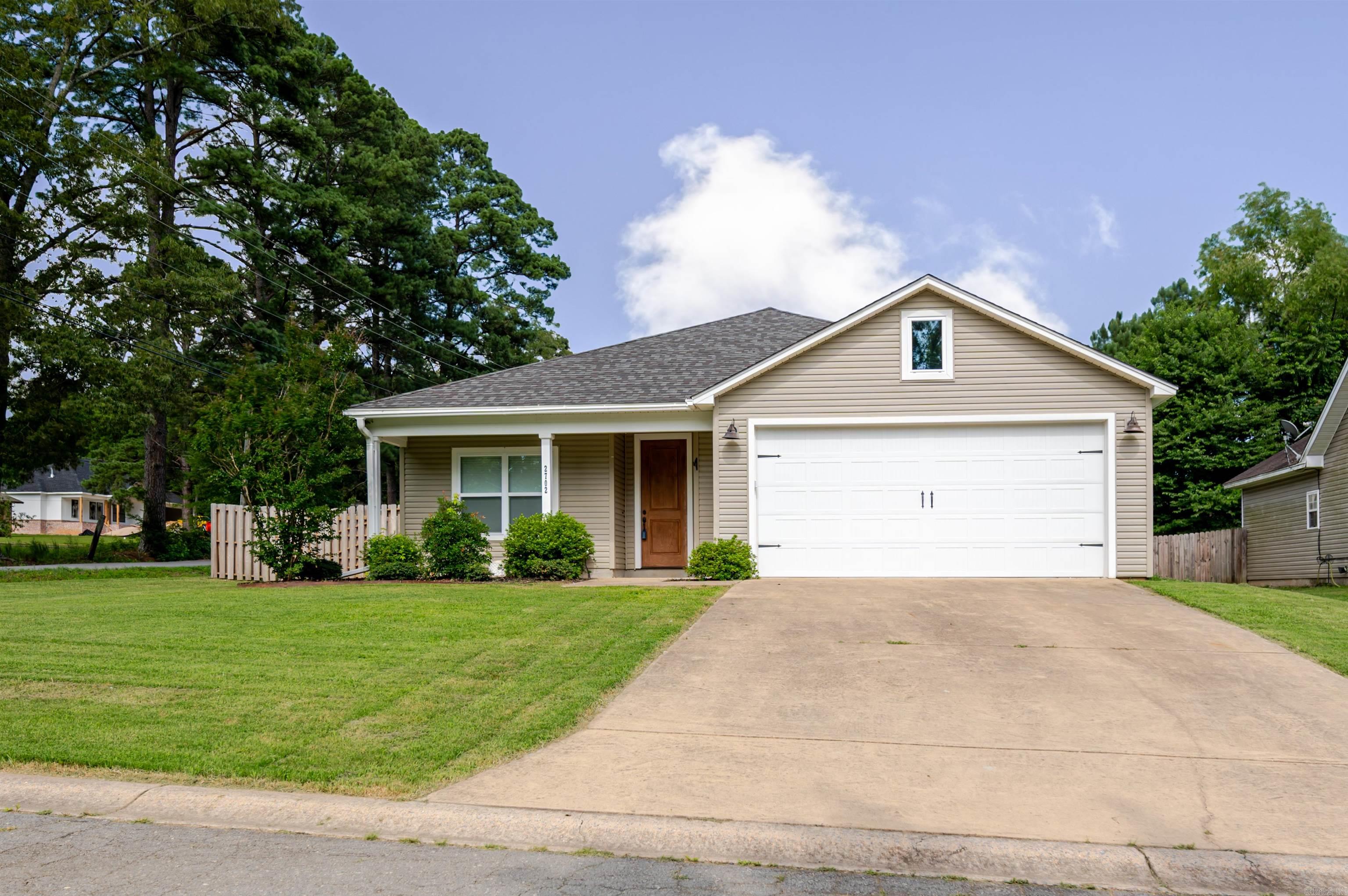 Tucked on a corner lot in the sought-after Sharon Oaks neighborhood, this Benton home offers both comfort and convenience. The thoughtfully designed split-bedroom layout provides privacy, while the open-concept living space brings everyone together. The kitchen is a standout with granite countertops, generous cabinetry, a large pantry, and a breakfast bar that flows easily into the dining area and great room—ideal for everyday living or entertaining. The spacious primary suite includes direct access to the laundry room, a walk-in shower, extended vanity space, and a massive walk-in closet. Additional highlights include a mudroom drop zone, ample laundry storage and folding area, sleek stained concrete flooring throughout, a covered back patio, and a level newly fenced, backyard ready for outdoor enjoyment.
