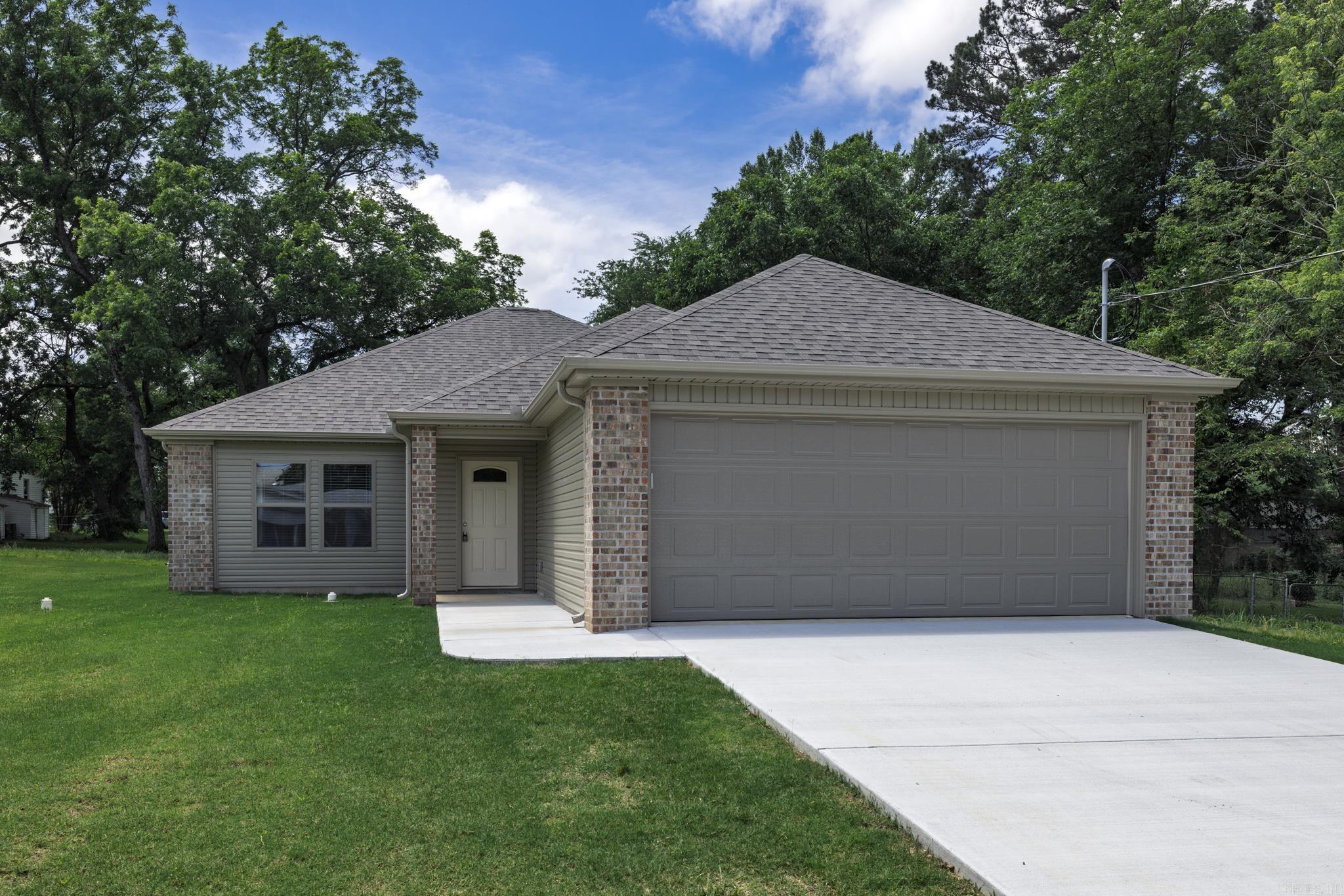 This beautiful new construction home offers 3 bedrooms and 2 baths on a spacious lot, providing plenty of room to enjoy. The open floor plan features luxury vinyl flooring, while the bedrooms are finished with plush carpeting for added comfort. The kitchen shines with stunning stainless steel appliances, perfect for both cooking and entertaining. The master suite is a true retreat, boasting a huge walk-in shower and an oversized closet with automatic lighting. A two-car garage provides ample parking and storage space. The seller is currently laying all-new sod, ensuring a lush, green lawn to complete this wonderful home.