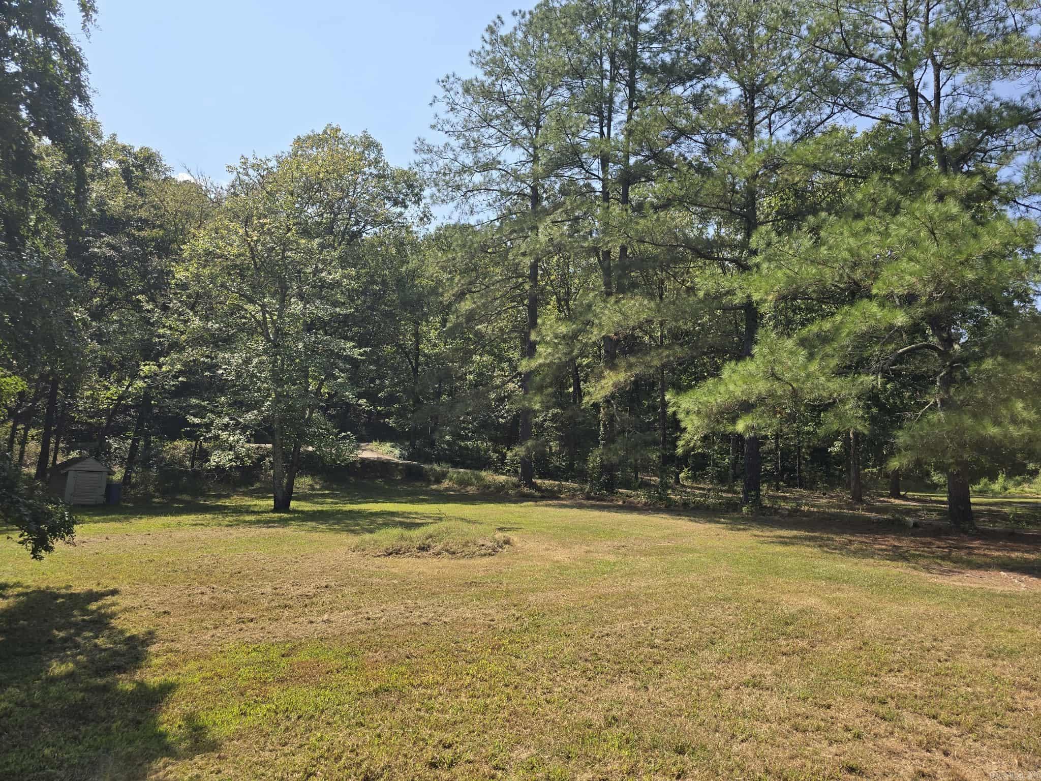 This is prime property. Off of Sunshine rd, borders hundreds of acres of National Forest on two sides, dead end road, and only a few minutes from Lake Ouachita. A hunters paradise! There is a dwelling currently on the property. It single wide mobile home with a 2-story addition added on to it. It needs a lot of work and is not livable in its current condition.Tear down and build your forever home. It would be hard to find better land and location than this! Owner is a licensed real estate agent in the state of Arkansas