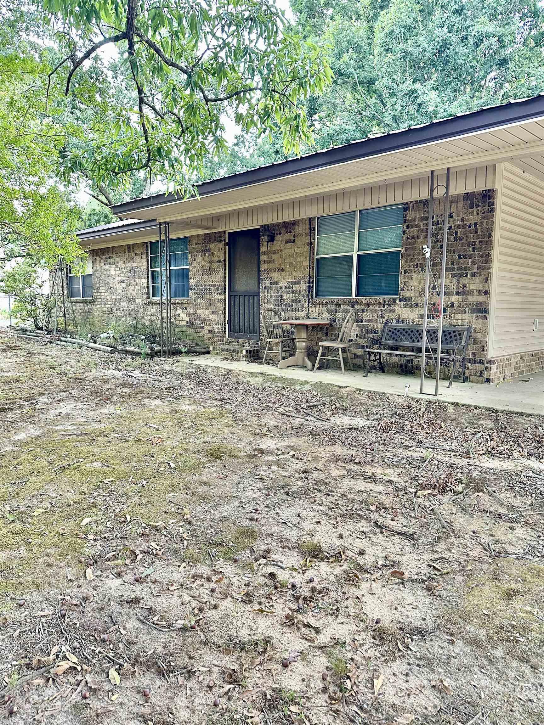 Your New Chapter Starts Here! This brick home is the perfect entry into homeownership, situated on a beautiful one-acre lot. 1,334 sf of well-designed living space, with 3 bedrooms and 1 bathroom. Enjoy quiet moments on the front porch, and peaceful surroundings. The home has a metal roof, offering peace of mind for years to come. The backyard is fully fenced, providing a secure area for family and pets to play. Additionally, the property includes 2 versatile shops, offering abundant space for hobbies, storage, or a dedicated workspace. This is a fantastic opportunity to embrace the peaceful country lifestyle.
