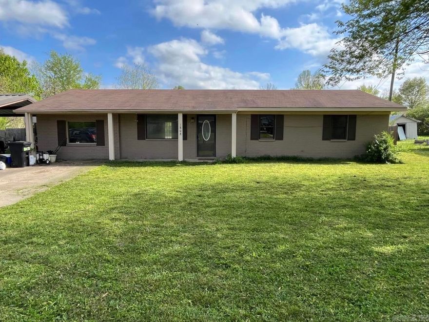 This nice, 3 bedroom/2 bath brick home sits on a large lot on a quiet neighborhood street. Spacious floor plan with an open concept living room. Cozy gas log fireplace. HUGE fenced backyard. Includes 16x20 shop with electricity, a 10x12 storage building, and a 12x20 metal carport. Great property to own in a lovely part of town!