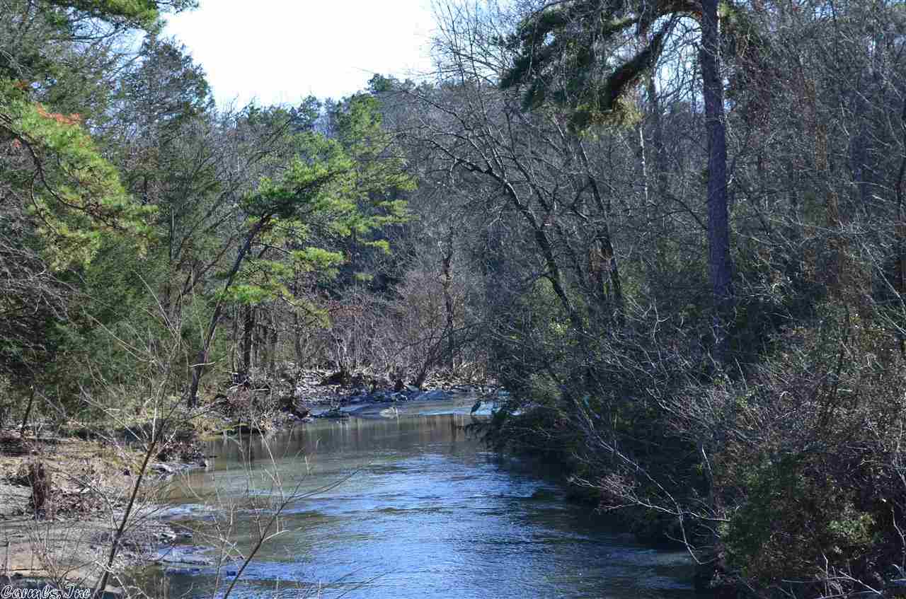 TOP OF THE BLUFF, OVERLOOKING THE CREEK, sets this like new, 2011 double wide home with an unfinished cabin. There are 8.5 acres with the creek, pond, and 20X30 shop wired for 220. Land has a mix of woods and pasture. Double wide has 1344 sq, 3/2 with porches. Cabin is a 20X24 shell waiting for your finishing touches. Really neat place.