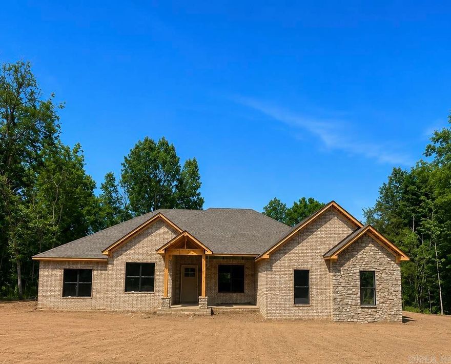 New construction underway in the gated subdivision of Devoe Bend by Daryl Brock Custom Homes. This stunning one-level residence is designed with today’s buyer in mind, offering 4 spacious bedrooms, 3.5 baths, and approximately 2,956 square feet. The home includes a 3-car garage and is situated on a level lot with picturesque views of the Bayou, plus greenspace at the back. Enjoy the neighborhood’s natural walking trails and tranquil setting. Quality construction features include ZIP System sheathing, TechShield roof decking, foam-insulated exterior walls, and a tankless water heater for energy efficiency. Interior selections are still available, allowing you to customize finishes and make this home your own. Built with craftsmanship and attention to detail, this property blends comfort, efficiency, and elegance in one of Maumelle’s most desirable gated communities.