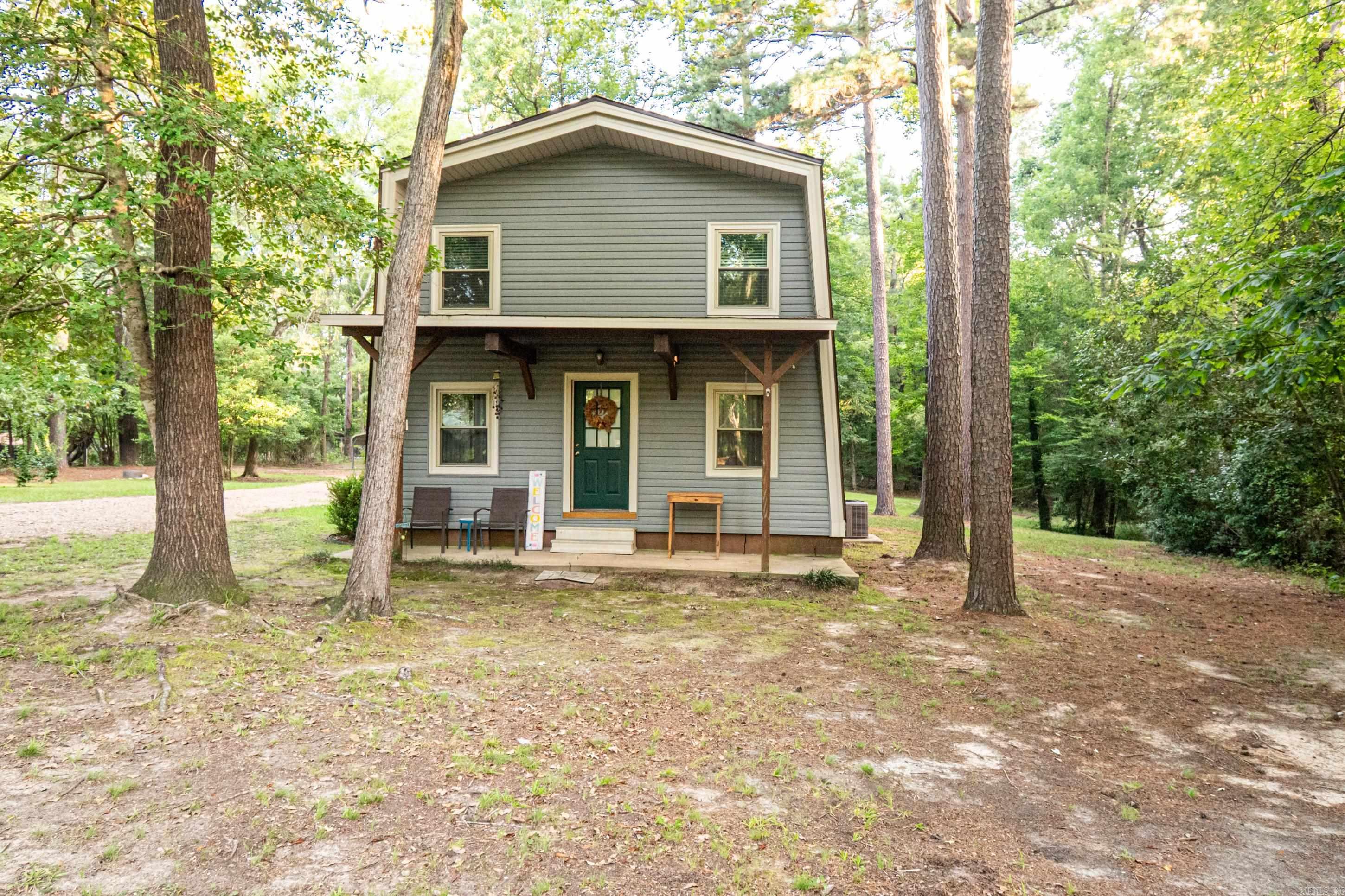 Charming A-frame on 1.5 acres at the end of a quiet rural streetāclose to town but with a peaceful country feel! The long, winding driveway adds a private touch as you arrive. A carport off the kitchen and a separate covered area offer space for vehicles, boats, or outdoor equipment, plus a small storage building. Inside features 3 bedrooms, 2 baths, and an open living area perfect for entertaining or creating a cozy game/dining space. The kitchen has a bar with seating that will convey, or thereās room to add a large island. Donāt miss the tucked-away pantry nook under the stairs. The spacious laundry room provides extra storage. Upstairs bedrooms offer privacy, ideal for separating guest space from living areas. Energy-efficient windows and 1ā insulation were added behind new siding installed in Nov. 2024āboth with lifetime transferable warranties. Utilities are low, helping keep monthly costs down.