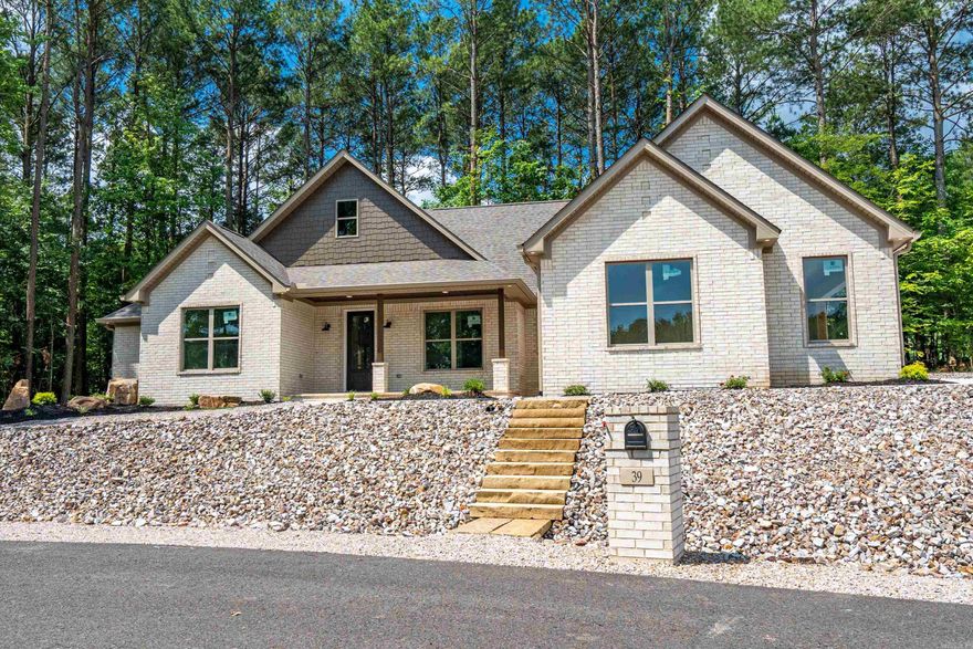 Stunning New Construction with Lake Views in Hot Springs Village! Located on the rapidly growing east side of Hot Springs Village, this beautifully designed home offers the perfect blend of luxury, comfort, and convenience. Enjoy serene views of Estrella Lake and a short golf cart ride to both Isabella and Granada Golf Courses.  Inside, you'll find soaring vaulted ceilings in the living room and master suite, quartz countertops, luxury vinyl plank flooring, and a cozy gas fireplace. The gourmet kitchen features floor-to-ceiling cabinetry, a gas range, walk-in pantry, and spacious layout perfect for entertaining. Custom landscape design enhances curb appeal, and the home includes thoughtful features like a hot/cold exterior spigot and stairs leading to attic storage.  Projected completion: June 15th – don’t miss your chance to own a lake-view gem in one of HSV’s most desirable areas!