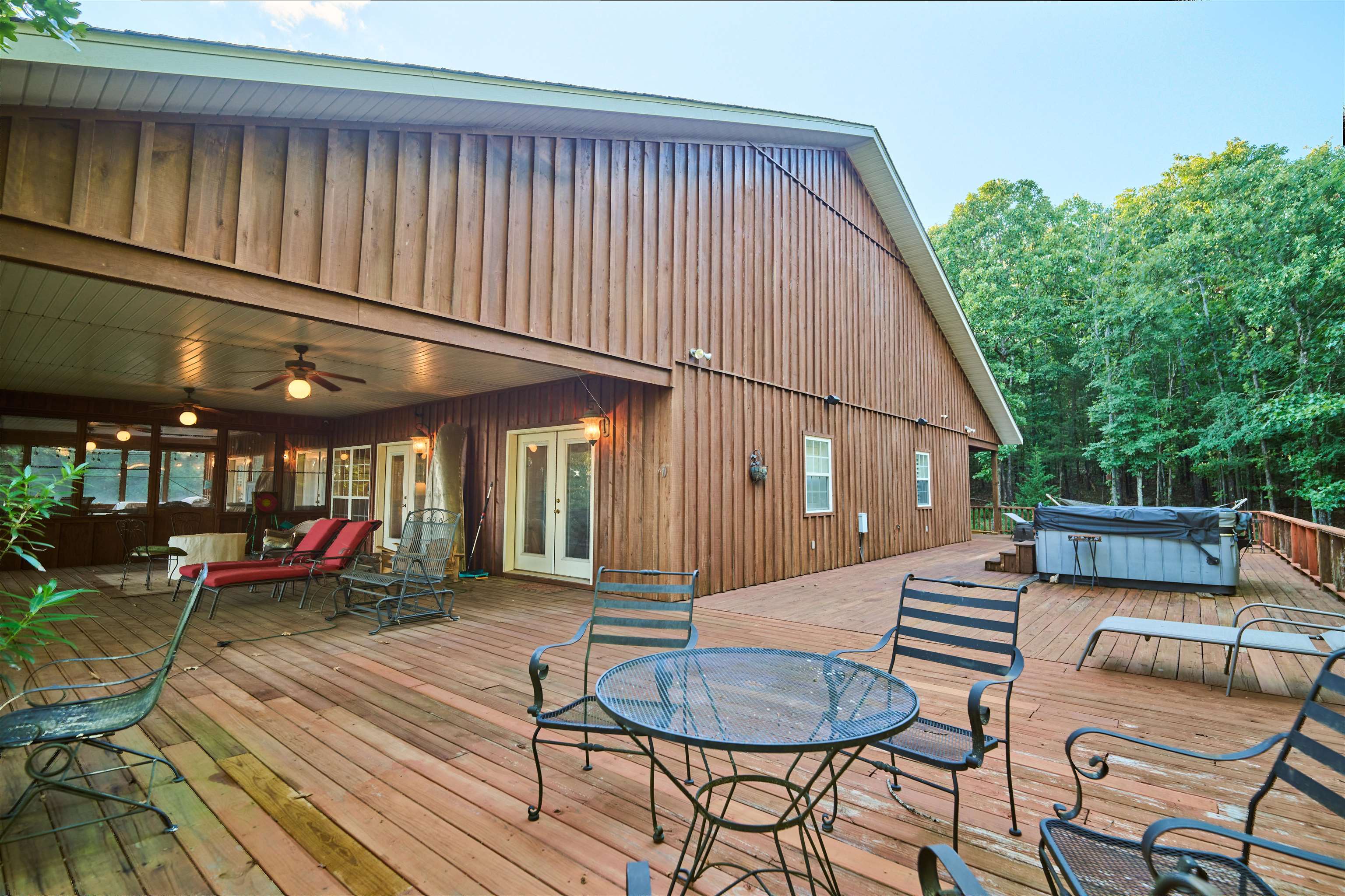 Ozark Mountain Lodge w/Breathtaking VISTA VIEWS overlooking mountains, valleys & lakes -There is a wrap around covered deck, ideal for entertaining or relaxing!! This unique Home boast 17 wooded acres+/-,& is a well kept secret nestled in the woods. This property is a outdoors person's paradise! The main lodge features a soaring vaulted ceiling, open floor plan w/ custom oak kitchen cabinets w/wine cabinet, built in cabinets in living room, custom window shutters & impressive stone wood fireplace! The primary en-suite has walk in closet & spa-like primary bath w/French doors to the outside screened sleeping porch. Sliding barn doors to guest rooms & another full bath. Air & security smart technology system! A generous laundry room leads to a double car garage. A short distance down the mountain you'll find a small hide-a-way fort for kids to use their imagination & perfect for observing wildlife. Take a nature walk trail to the guest cottage w/all amenities & views-ideal for overflow w/privacy & breathtaking views. The wooded land offers a natural environment for hiking & exploring. Spring River, nearby offers challenging float trips. Truly, this is an investment grade property!
