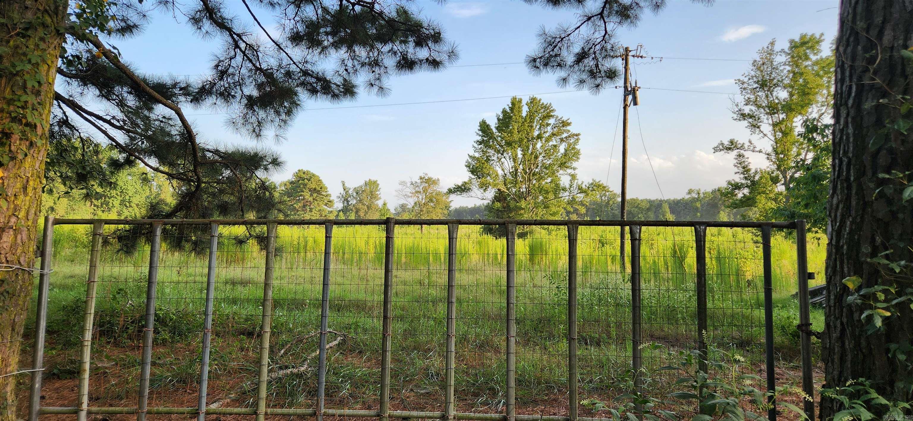 40 acres of fenced pasture land. Had cows on it recently. Has some timber. Beautiful House spots with electricity and Water on Evergreen Road. 1/4 road road frontage. Approx. 2 miles from I530. Seller will split. Agent see remarks.