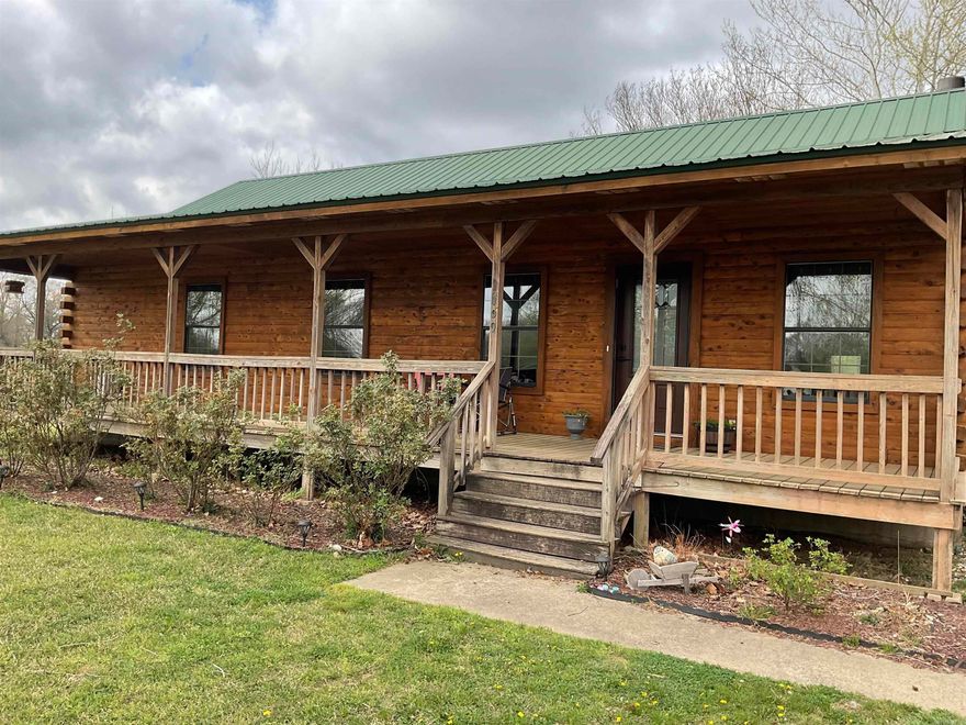 NEED A PLACE FOR YOUR HORESES AND YOURSELF?  THIS IS THE PERFECT PLACE.  Watch them roam and graze on your pastured fenced-in 4.4 acreage from the brand new deck the seller just added or even from the full length front porch that even provides your rockers. In side is wonderful wood flooring & ceilings.  Exterior walls are wood and interior walls are sheetrock.  The home consist of a warm cozy wood-burning fireplace that can easily be converted back to gas logs should that fit your life style better. A host of extras such as new appliances, beverage center, breakfast bar, open kitchen/dining/den, window blinds, drop cabinets and can even come completely furnished with some of the most beautiful Amish made furniture you have ever seen at an extra price of $60,000 (and well worth it). A MUST SEE. Dont let the cats out peeps!