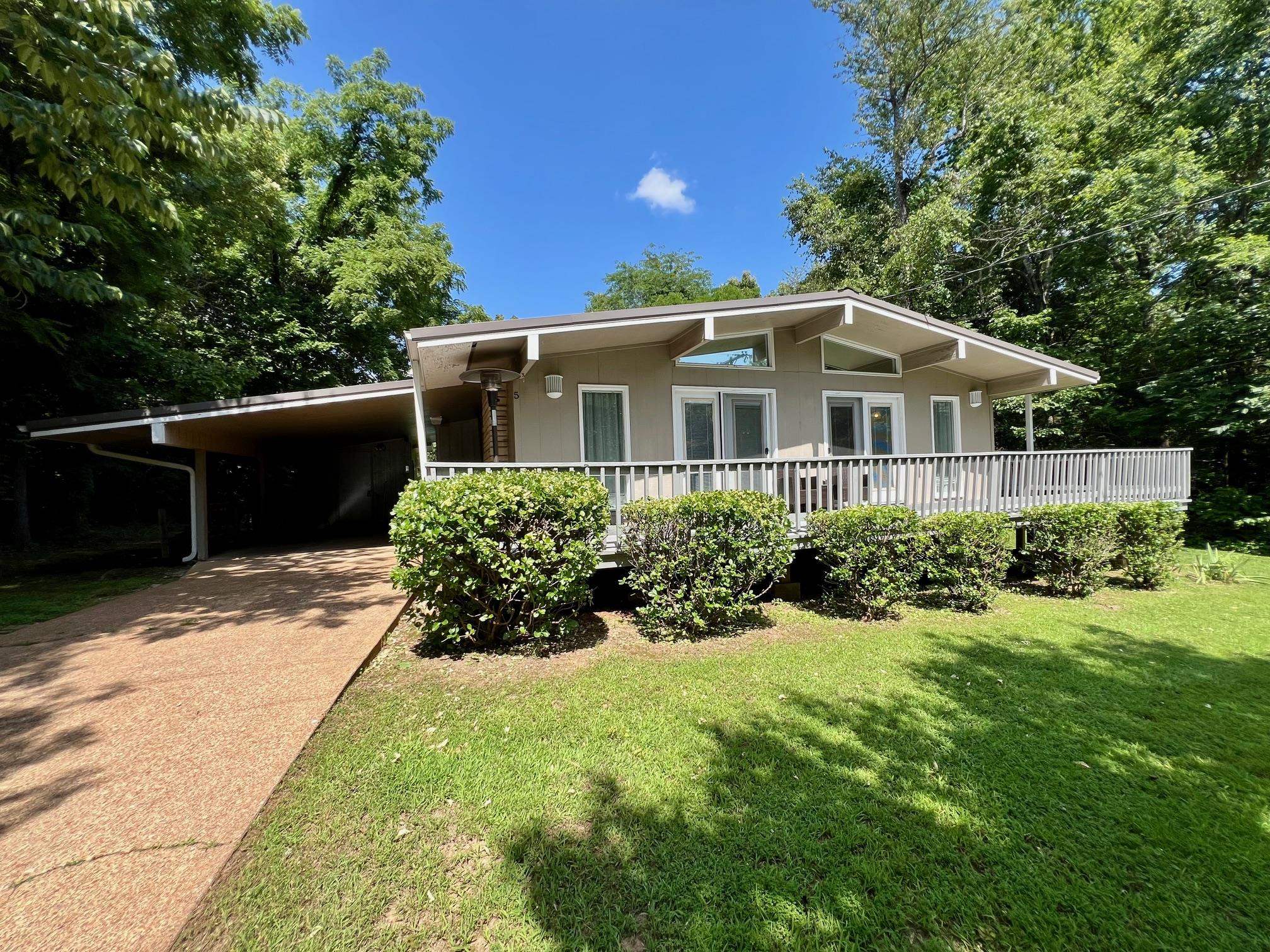 This charming 2-bedroom, 1.5-bathroom home offers the perfect escape in the heart of Cherokee Village. Ideally situated across from Lake Thunderbird and Wetappo Park, outdoor lovers will find plenty to enjoy just steps from their front door. Whether you're seeking a vacation retreat, an Airbnb opportunity, or a full-time residence, this home offers ease, comfort, and convenience. Step inside to find an inviting living space filled with natural light, anchored by a cozy gas insert fireplace—perfect for warming up those cooler Ozark evenings. The thoughtfully designed layout includes an updated HVAC system installed in 2018 and a durable metal roof added in 2021, offering peace of mind and efficiency. Enjoy morning coffee or evening gatherings on the spacious front deck, which overlooks a quiet neighborhood known for its relaxed lifestyle and welcoming community vibe. The oversized storage area built into the carport is ideal for stowing away outdoor gear, hobby tools, or your ever-growing collection of fishing rods. Located just minutes from local schools, grocery stores, and the Thunderbird Recreation Center, daily errands and leisure activities are easily within reach.