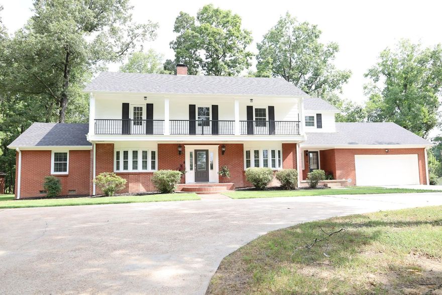 Welcome to 1701 Barnhill--a stunning blend of timeless character and modern updates, all nestled on 2.00 acres m/l inside city limits in one of the area's most desirable locations.  This beautifully maintained home offers 5 spacious bedrooms, 5 full bathrooms, and a dedicated office, with one bedroom conveniently located on main floor.  With 3,040 sq ft of living space plus an additional 1,401 sq ft of finished basement, there's room for everyone and everything. Step inside to find a completely remodeled kitchen and main floor bath, featuring quartz countertops, stainless steel LG high-end appliances, and fresh flooring and paint throughout. All new exterior doors and windows, along with a new roof and two HVAC units (installed just 3 years ago), offer peace of mind for years to come. The water heater is just 2 years old, and the home is equipped with two newer sump pumps in basement, inspected annually for added protection. Other recent upgrades include blown-in attic insulation, new gutters and a leaf filter system. The newly upgraded balcony with updated railings offers a peaceful place to enjoy the outdoors. This home has it all-modern functionality and vintage charm in one!