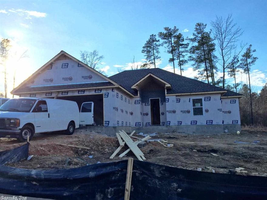 Brick and board and batten home, open floor plan, crown molding, huge island in kitchen, granite counter tops throughout, handscraped wood laminate flooring in all main areas. Large custom tile shower in master bathroom, covered back porch.