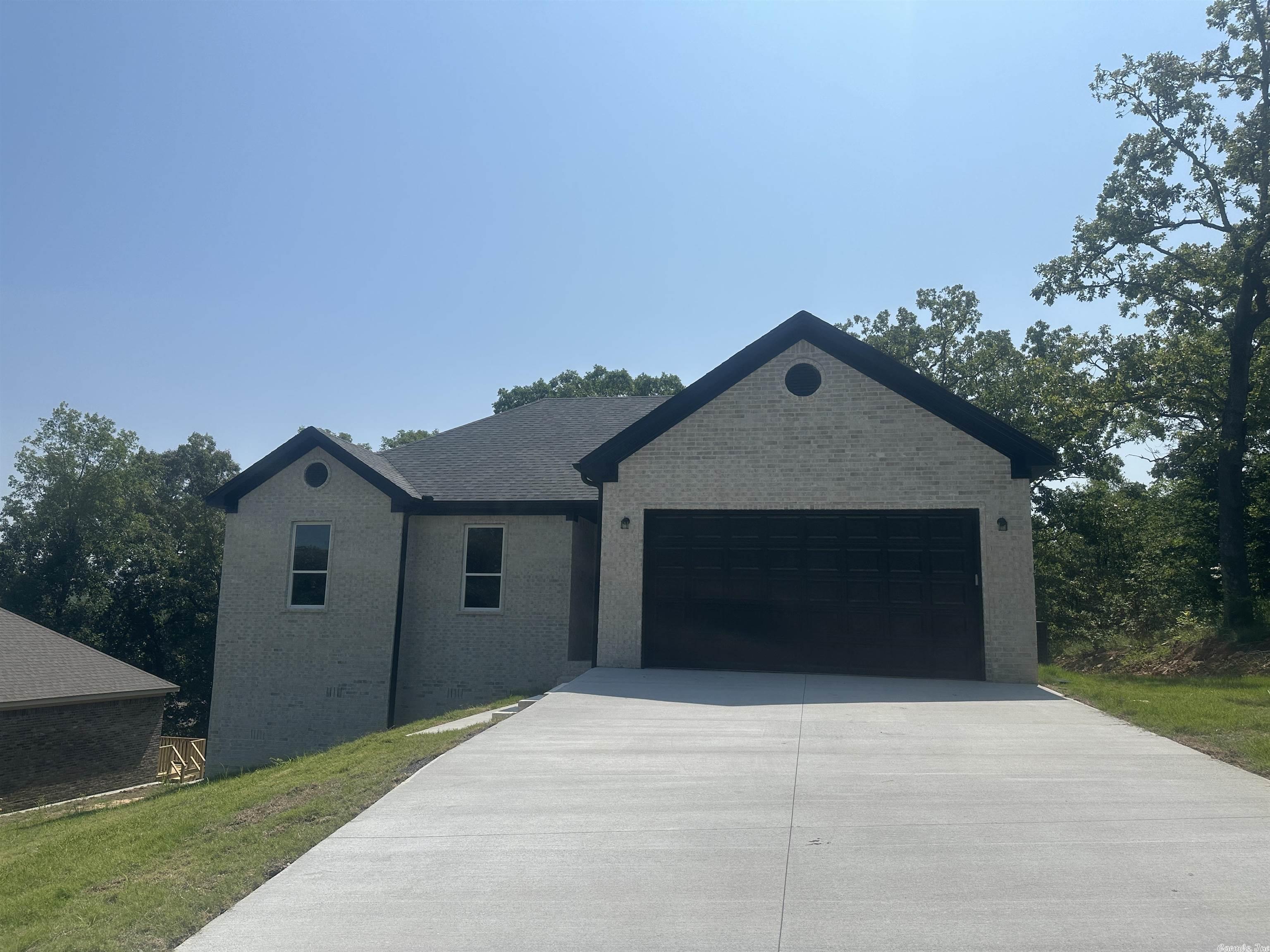 BRAND NEW ALL BRICK HOME!!! Open floor plan with luxury vinyl flooring throughout for easy care! Granite counters in kitchen and bathrooms and beautiful light fixtures! Kitchen has big pantry and lots of cabinetry. Separate laundry room with door (no walking through laundry area to kitchen!) Breakfast bar, nice dining space overlooking trees in back yard-nice country feel! Electric log fireplace-clean and sleek! Primary bedroom and bath on back of the house for quiet feel. Double vanities and walk in closet also. Check out the cool bathroom fixtures. Gutters on front of house and nice deck on the back. Cool light fixture in garage too!