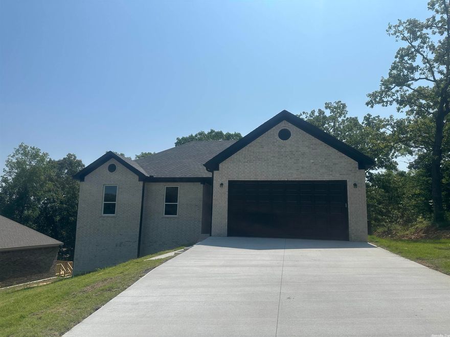 BRAND NEW ALL BRICK HOME!!!  Open floor plan with luxury vinyl flooring throughout for easy care!  Granite counters in kitchen and bathrooms and beautiful light fixtures!  Kitchen has big pantry and lots of cabinetry. Separate laundry room with door (no walking through laundry area to kitchen!)  Breakfast bar, nice dining space overlooking trees in back yard-nice country feel!  Electric log fireplace-clean and sleek! Primary bedroom and bath on back of the house for quiet feel. Double vanities and walk in closet also.  Check out the cool bathroom fixtures.  Gutters on front of house and nice deck on the back.  Cool light fixture in garage too!