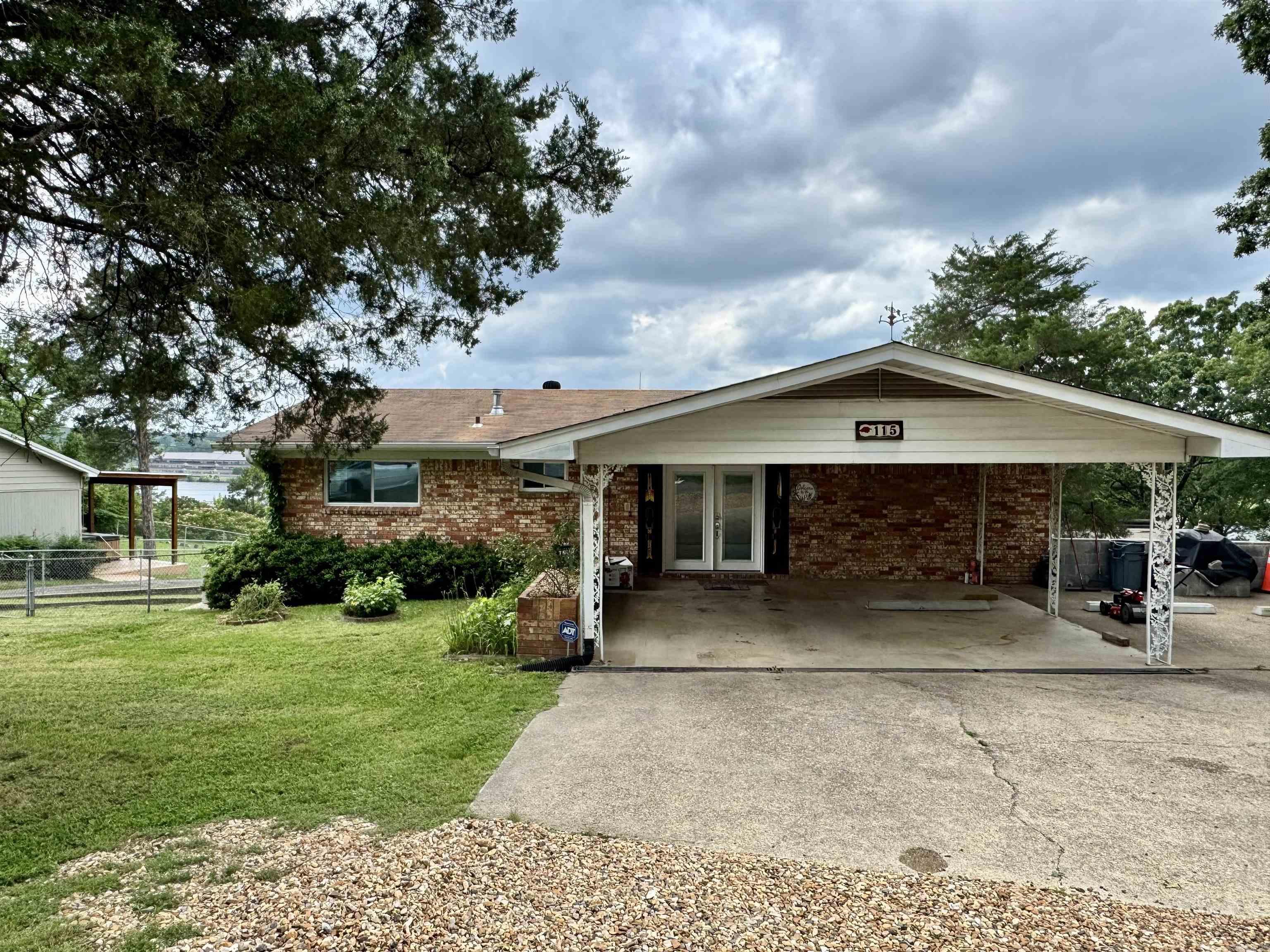 The lake is calling! Spacious and updated, this Lake Hamilton home is move in ready. The open lake views will not disappoint. This home was updated in 2023 and has a history of both short and long term rentals. Featuring two levels with living rooms on both levels, 2 bedrooms, 1 full bathroom and kitchen upstairs and 2 bedrooms, 2 full bathrooms and a wet bar downstairs. This home is designed to accommodate guests. The outdoor space is abundant with a large covered deck upstairs and a screened in covered patio below. The single stall boat dock sits along the 95 feet of shoreline. Selling fully furnished. Covered 2 car carport. Bring all offers!