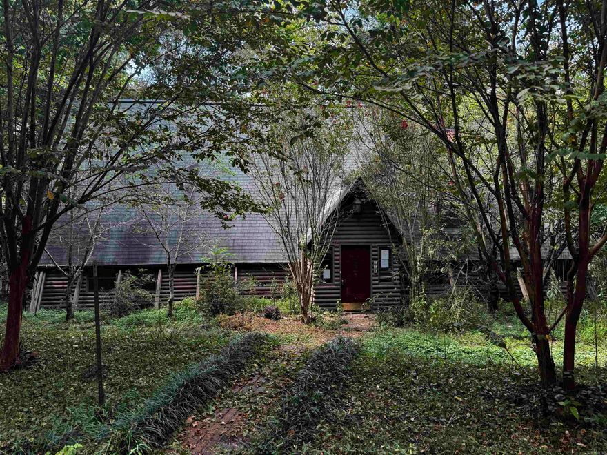 Located just 30 minutes from Hot Springs, AR, this beautiful A-frame, two-story log home sits on a serene 7+acre lot. Inside, the open-concept living space features four spacious bedrooms and three baths, offering ample room for a large family. The property includes a nice storage building and plenty of land for gardening, making it perfect for those who appreciate both comfort and nature. Tucked away in a secluded area, this home offers peace and privacy, allowing you to enjoy the tranquility of your surroundings. Start your mornings with a cup of coffee on the upstairs deck, where you can watch deer peacefully roam the backyard.