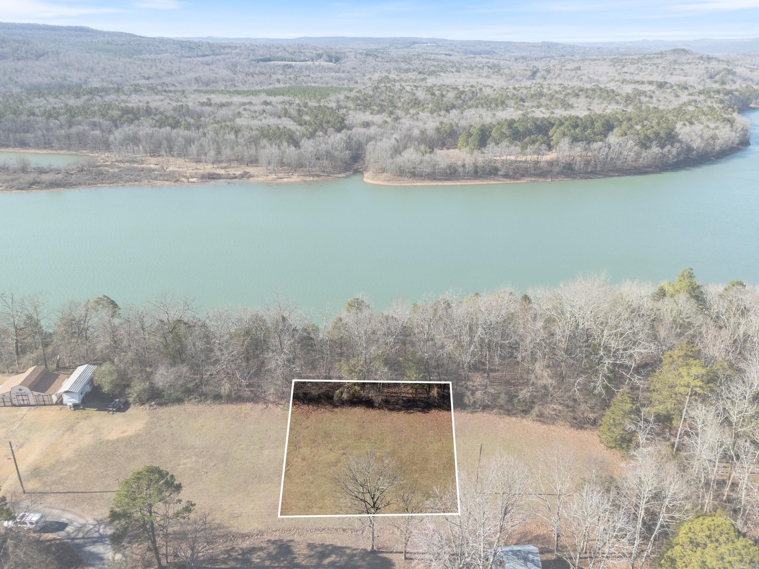 Discover your dream retreat with this stunning lake view lot in the serene Whispering Pines subdivision, overlooking the breathtaking Greers Ferry Lake. This .59-acre lot offers the perfect setting to build your custom cabin, surrounded by nature and featuring picturesque lakefront views. Additional lots are available for those seeking more space to expand your property. Utilities are conveniently located, making the building process smoother. Whispering Pines ensures a tranquil and well-maintained community, with no mobile homes allowed. Don’t miss this rare opportunity to own a piece of paradise and create the lakeview getaway you’ve always envisioned. Contact us today to make it yours!