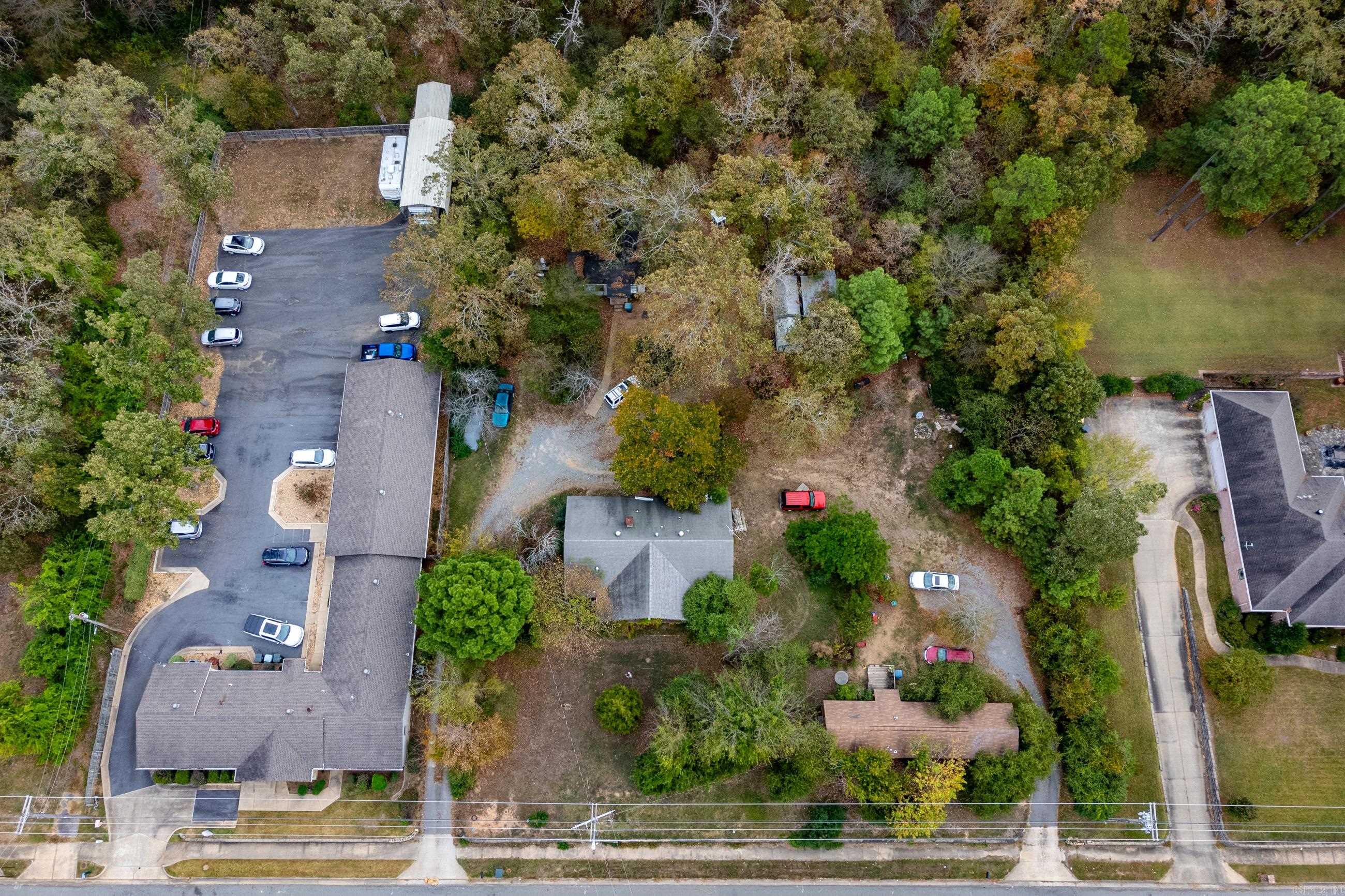 Fantastic lot in the middle of the city surrounded by commercial property with great visibility and traffic! Perfect location for a business like those surrounding and developing in WLR. Lot is flat, private and wooded. Three dwellings currently on the property occupied by owners.