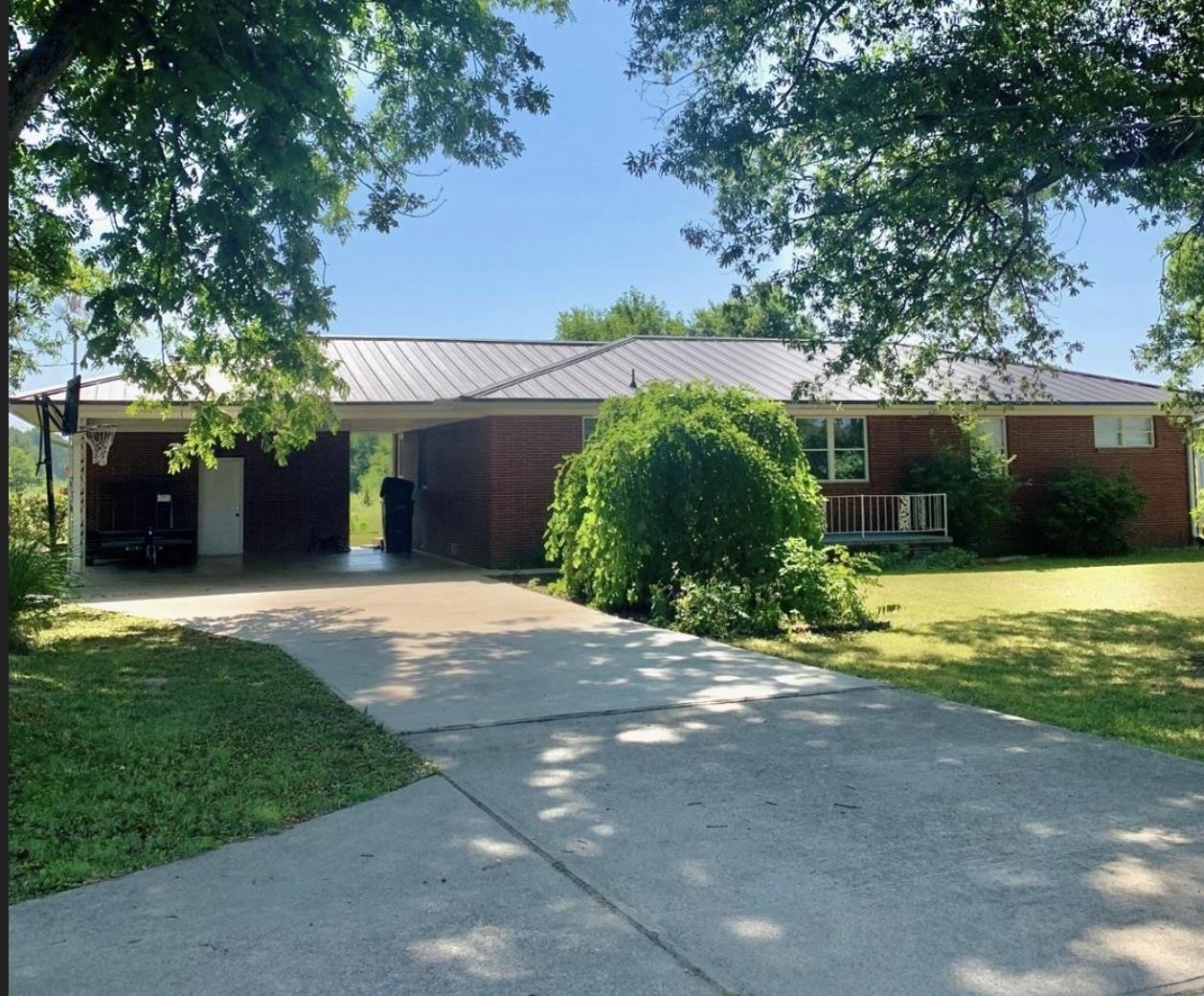 Country living with the convenience of town! This adorable ranch-style home is right on the edge of town with a large yard, fruit trees and mature pecan trees. Stepping through the front door you will find a great open floor concept. The kitchen has plenty of storage space with solid oak cabinets and solid surface counter tops, complete with a large Island. The living room is perfect for large families or get togethers. The focal point of the living room is the fire place that is a Hallmark Movie dream! In addition to the three bedrooms, two bathrooms, and ample storage space, you will also find a beautiful sunroom that connects to your large laundry room. The backdoor off of the laundry room lead out to the vast back yard. The yard is fully landscaped with a fenced garden area that has a small pond perfect for your koi fish. You will also find a nice storm shelter in the yard. Need a shop? A 30x32 detached shop building with its own electric meter, gas heat and half-bath makes a nice added feature. So many more features... Call today to make this your new Home!