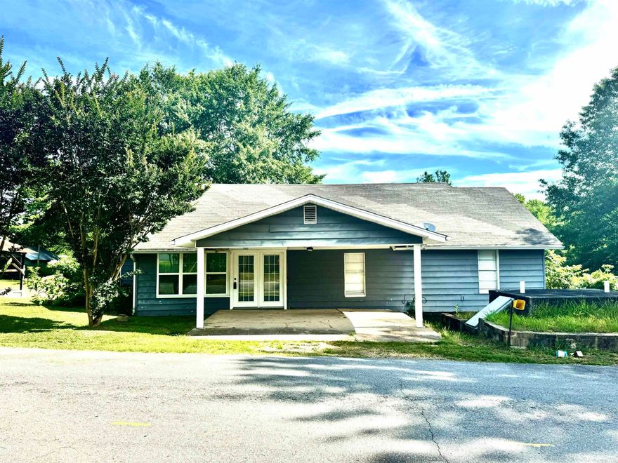 Discover the charm of this cute 3-bed, 1-bath home nestled on a spacious 0.88-acre lot, featuring durable hardie board and aluminum siding. Boasting both vinyl flooring in the kitchen and dining area along with hardwood flooring throughout the rest of the home. This home offers a functional layout with two bedrooms conveniently located on the main floor as well as the full bathroom. Upstairs, you'll find a third bedroom and across the hallway a spacious bonus room, perfect for a home office or additional living space. The home features a cozy sunroom, an ideal spot for enjoying a good book or sipping your morning coffee. Recent upgrades include a new hot water heater and sewer lines extending to the street, both installed in 2023. Additional amenities include multiple storage buildings and a substantial 12-person storm shelter, providing ample space and security. This property is a perfect blend of comfort and practicality, ready to welcome its new owners.