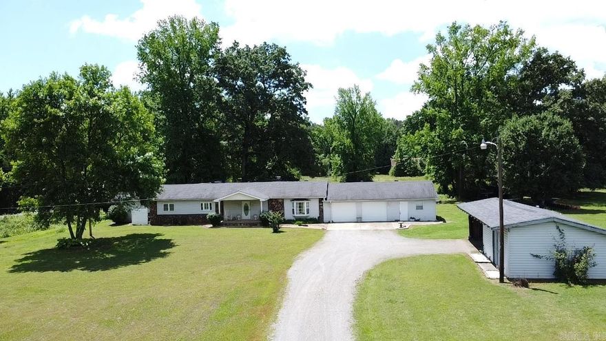 A little piece of country in the Mountain foothills. This beautiful custom built, 3 bedroom 2 bath home is nestled just as you begin the climb up into the Ozark Mountains. Home sits on 7 acres m/l with a park-like back yard where you can sit inside the screened porch, open deck or on a swing watching wildlife, while listening to a babbling stream with a footbridge crossing into a field containing a rustic barn. Home has a 2 car oversized garage, additional workshop, equipment shed, and storm shelter. The inside has an inviting fireplace, custom cabinetry, built in closet shelving, large walk in primary closet, alarm system and tons of storage thorough-out. New HVAC in 2024. New flooring with luxury vinyl & tile, subflooring and vapor barrier throughout in 2021. New roof 2022.