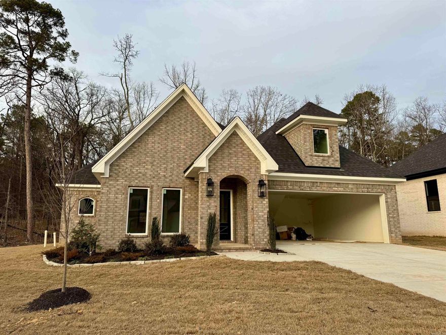 Beautiful New Construction Home with Resort Style Amenities, located in the newest phase of Hurricane Lake Estates. Sitting Just across from the Lake, This thoughtfully designed home offers 3 bedrooms, 2.5 baths, Plus a versatile Bonus Room. The open-concept living and kitchen area is ideal for entertaining, complemented by a dedicated dining room. The spacious kitchen features a huge island with quartz countertops and flows seamlessly into the living room with wood beam accents and a cozy fireplace. Double doors open to a peaceful wooded view, bringing the outdoors in. The primary suite boasts a luxurious soaking tub and a large walk-in closet. Enjoy all the amenities Hurricane Lake has to offer, including a pool, tennis courts, lake access, walking path, and playground. Located in the highly sought-after Bryant School District with convenient access to Little Rock, Benton, and Bryant. Completion expected February 10th.