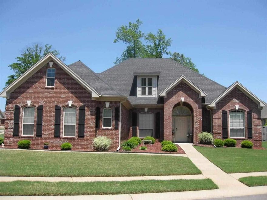 BEAUTIFUL BRICK HOME ON CORNER LOT WITH 3 CAR GARAGE! Open floor plan with 4 bedrooms & 3 baths. 4th bedroom could be used as an office. You'll love the HUGE great room with fireplace & wood floors! Kitchen features breakfast bar with granite countertops & maple cabinets.  Formal dining room.  SPACIOUS master bath features his/her vanities, jetted tub & separate shower. 2" blinds throughout house. Laundry room has sink & folding area.  Privacy fenced backyard, guttering & covered patio.