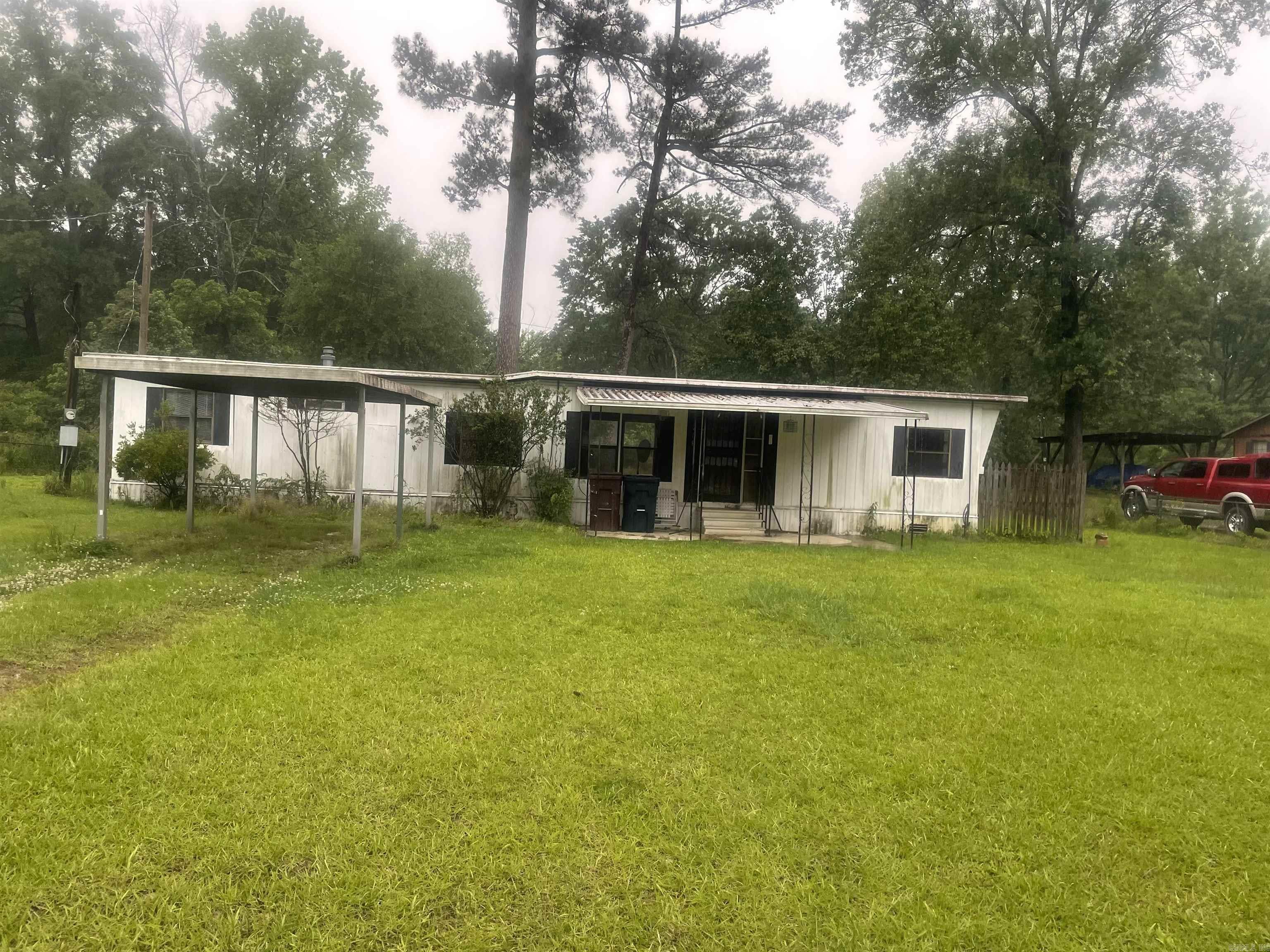 Check out this mobile home for a first time home buyer or for a rental investment property located in a nice neighborhood. Needs a few updates but not much to make livable. Perfect for single person or a couple. 10x20 Patio, fenced in for pets, storm shelter, 1 car carport, and a 10x10 utility building. Just minutes from the White Hall and I-530 Exit off 270 Hwy