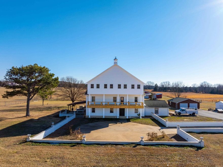 This extraordinary 3-story estate offers luxury, versatility, and fenced pasture ready for animals. As you turn off Highway 230, a paved, tree-lined driveway welcomes you to this remarkable property. In front of the home, a large concrete area has been prepared for a grand fountain or waterfall, ready for the next owner’s vision. The property includes cross-fenced pasture, barn, Grange Calamine water, a pasture well, and county water access. The home is all-electric with Entergy service. Offering 6,385± sq ft, the residence features porcelain tile flooring, updated electrical and plumbing, custom draperies, new LP siding, new decks, and a roof approx. 3–4 years old. Three furnace systems (one per level) and two water heaters provide efficiency. A secondary gallery kitchen with stainless appliances and granite countertops is currently used as the primary kitchen, located off the garage with a half bath and laundry room. The 19x39 indoor heated saltwater pool is housed in a 1,984± sq ft climate-controlled building with Pool Pak system and robotic cleaner. A rare blend of luxury, land, and limitless possibilities.