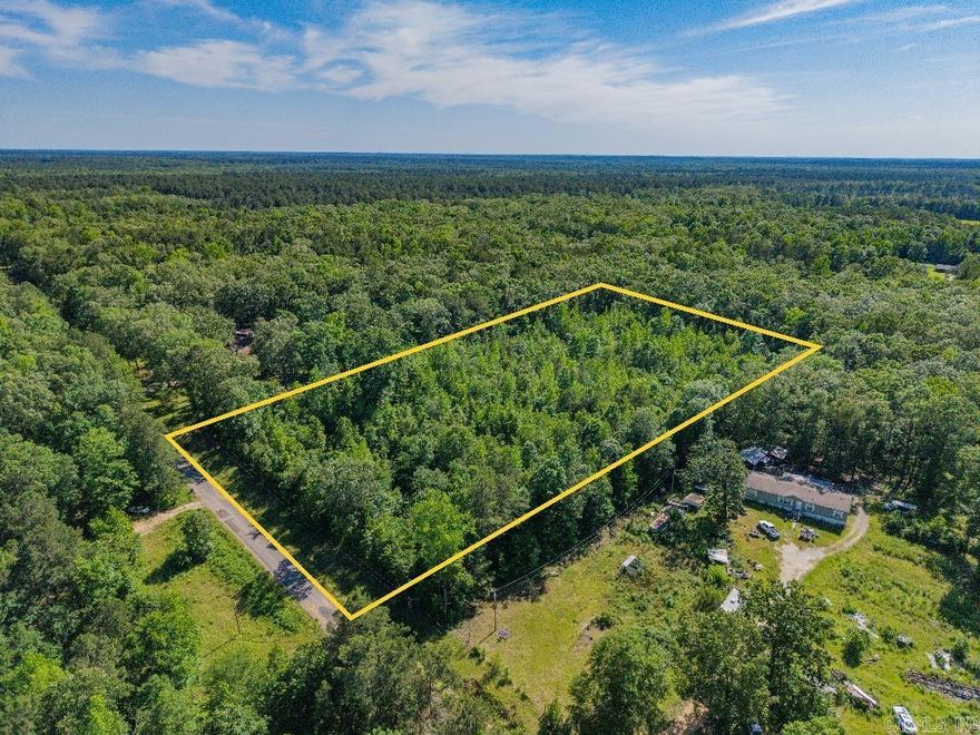 Wooded 5.11-acre parcel on Pinewood Drive offers privacy, space, and flexibility. Features road frontage and  water and power lines available for hookup at the street. Suitable for building a home, cabin, RV, or mobile. No HOA restrictions allow freedom to use the land your way. Convenient location near Rison with easy access to Pine Bluff and Little Rock. A great choice for buyers seeking country living or long-term investment potential.