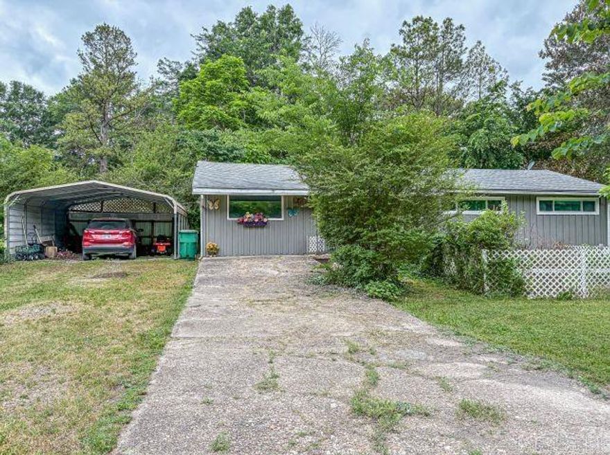 Home located in city limits of Flippin allows convenience for shopping, school and other needs.  This home is on a corner lot with mature trees, has 3 bedrooms and 1 bathroom.  There are also a separate utility room and a bonus room that can be used for office, storage, hobby space or anything you want to make it.  Newer double pane windows, blinds, ceiling fans are just a few things that makes this a cozy place to call home.