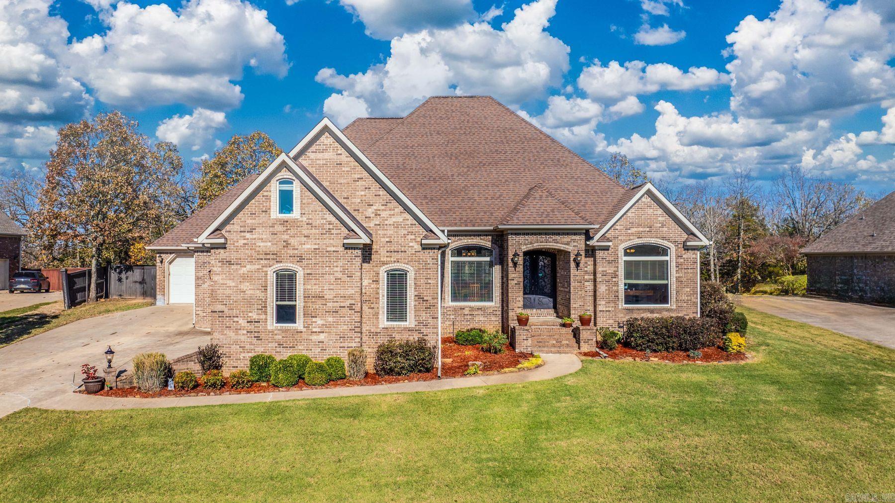 Fall in love with this freshly painted, custom-built home with an open, spacious living, dining and modern kitchen with a large gas range and granite countertops perfect for entertaining. There are 4 bedrooms and 3 bathrooms on the main level. The upstairs has a large bonus room for an office or a workout space, plus a cozy media room, and a half bath for enjoying movie nights. Updates include a primary bathroom remodel, a NEW A/C and all NEW flooring throughout the home in 2022. Additional features include a spacious 8x10 Safe Room off the laundry, hardwood flooring, wireless exterior lighting, a third garage or shop space and 2ā wooden blinds. Extensive crown molding adds a touch of elegance to every room. The home is nestled on a quiet lot that backs up to green space providing the serene location for morning coffee while offering added privacy. The extended patio behind the primary bedroom is 220 wired for a hot tub.