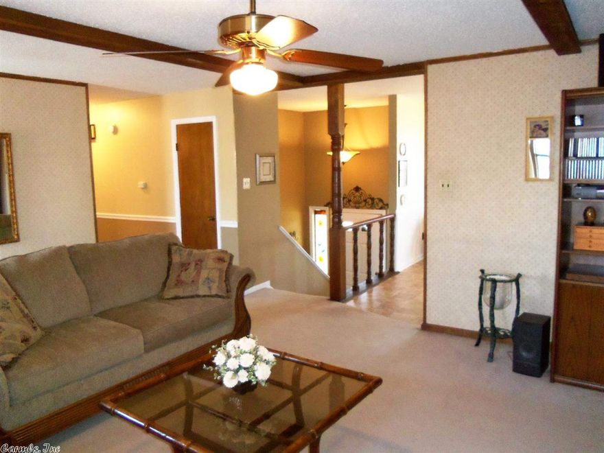 Park Hill convenience w/ newer amenities! Large living area w/ box beam ceiling & wood burning fp opens nicely to kitchen/ dining area. Kitchen features updated floor covering & appliances. Spacious main level master w/ walk-in & full bath. Downstairs den, half bath, & former BR converts easily back into teen/ in-law qtrs. Dbl end load garage w/ auto openers. Enjoy fireworks/ city view from deck, or relax at the screened porch. A backyard brook in a backyard oasis w/ designer quality landscape. Garden spot!