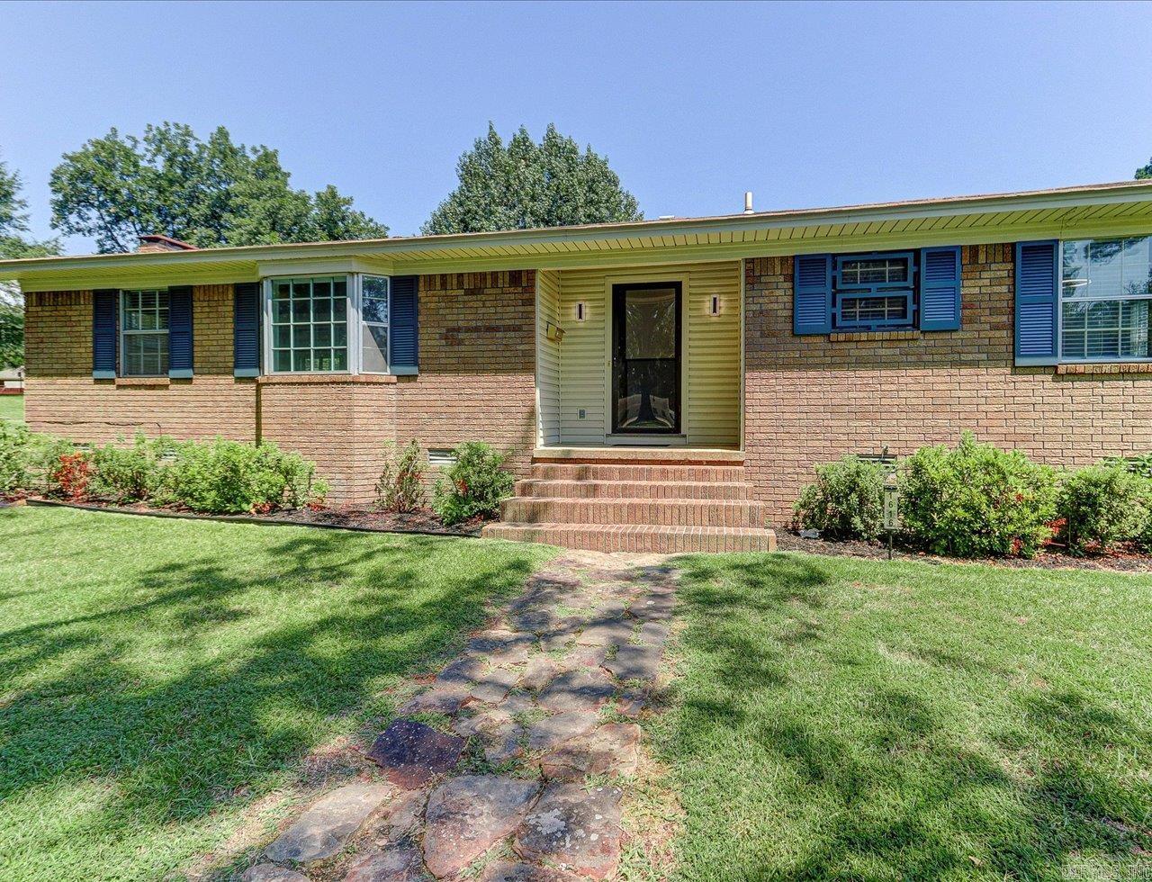 Beautiful, all brick family home located on one of Malvern's most iconic streets. 1616 Pine Bluff St will blow you away! From the large .78 acre lot, to the meticulous renovation and updating, this home is ready for today's families. Abundant light enters the home with its large and well-placed windows. Space should not be an issue with lots of room to spread out in either the large front living/dining room or the den located off the kitchen with built-in bookshelves and a gas fireplace. The kitchen boasts granite countertops, new appliances, and tons of cabinetry & counterspace with a breakfast bar. A large sliding door leads you out to the rear patio and lets in tons of natural light. A large primary en-suite bedroom has its own private entrance to the well landscaped rear patio, that feels private and secluded. The large tile walk-in shower feels luxurious. Two nice size bedrooms and a second bath round out this amazing property. A new HVAC unit was installed in 2025 as well as new insulation. Also, all new flooring, paint, bathrooms, kitchen appliances, outlet plugs & switches were installed. Don't miss the opportunity to make this lovely property your family's new home.